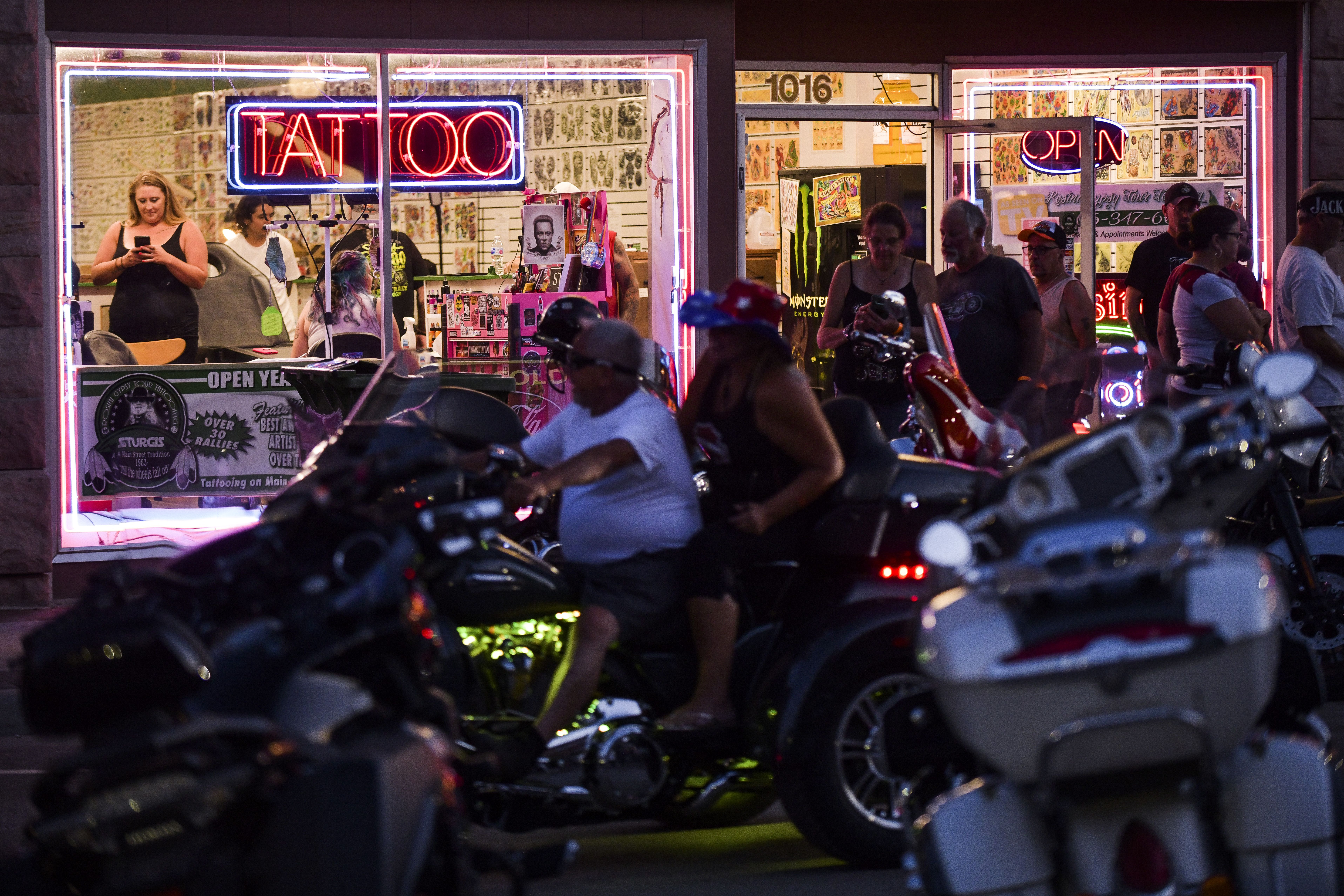 People outside a tattoo parlor in Sturgis on Aug. 7.