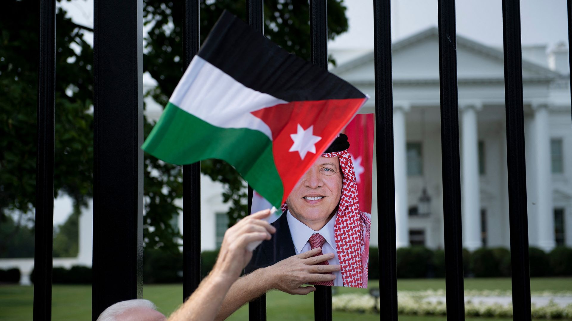A photo of Jordan's King Abdullah II is seen in front of the White House.