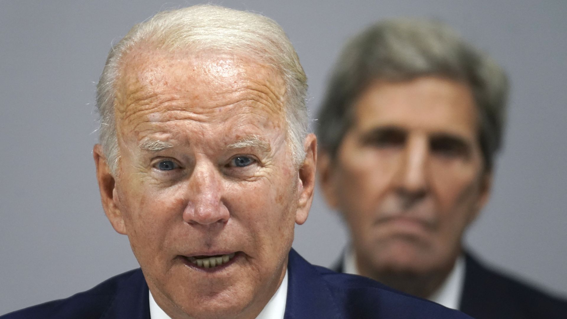 Climate envoy John Kerry is seen looking on as President Biden addresses the COP26 climate meeting in Scotland.