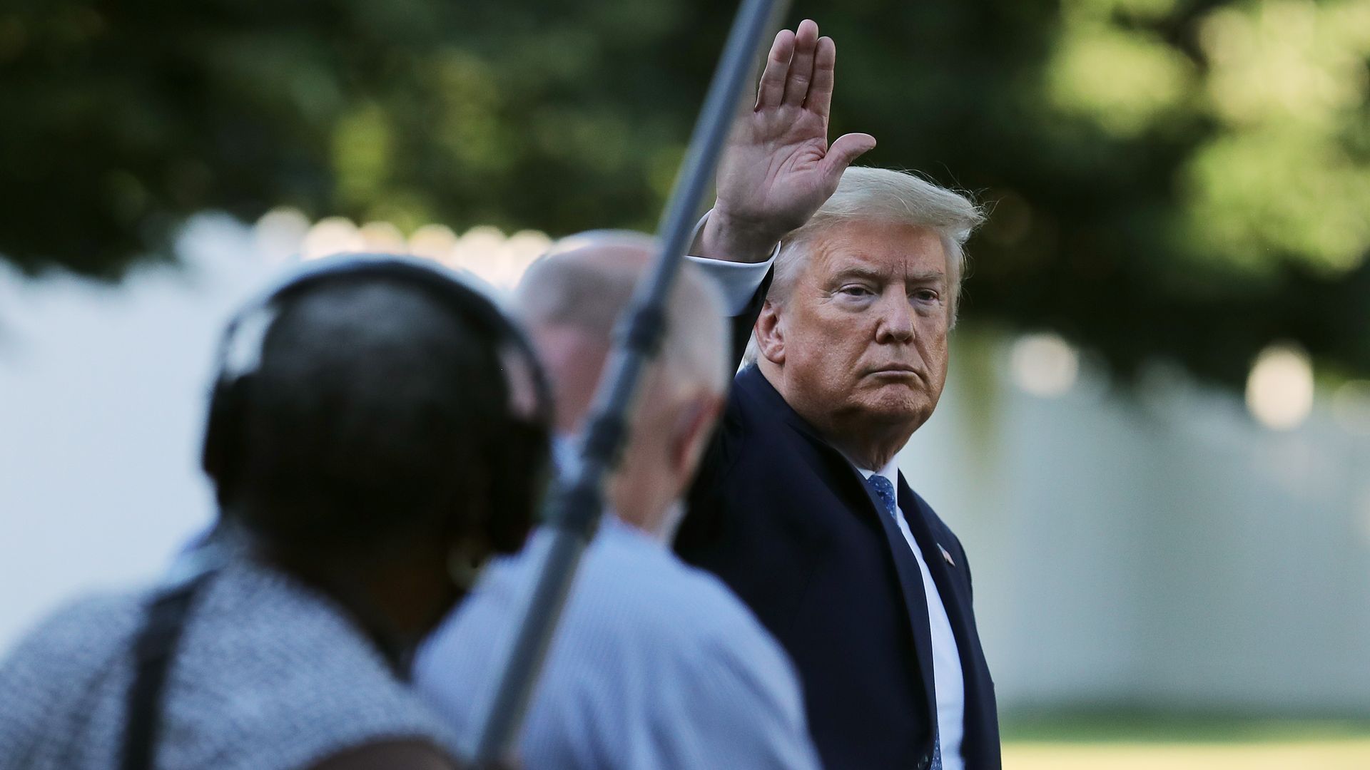 President Trump waves to reporters outside the White House.