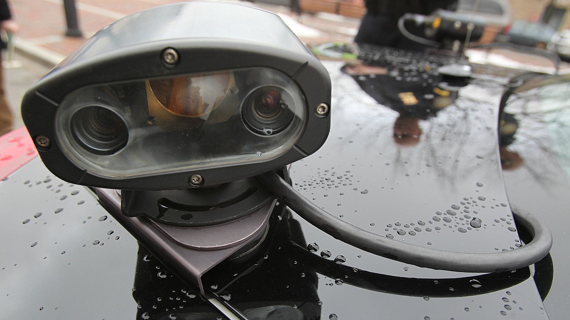 A camera is mounted atop a patrol car. 