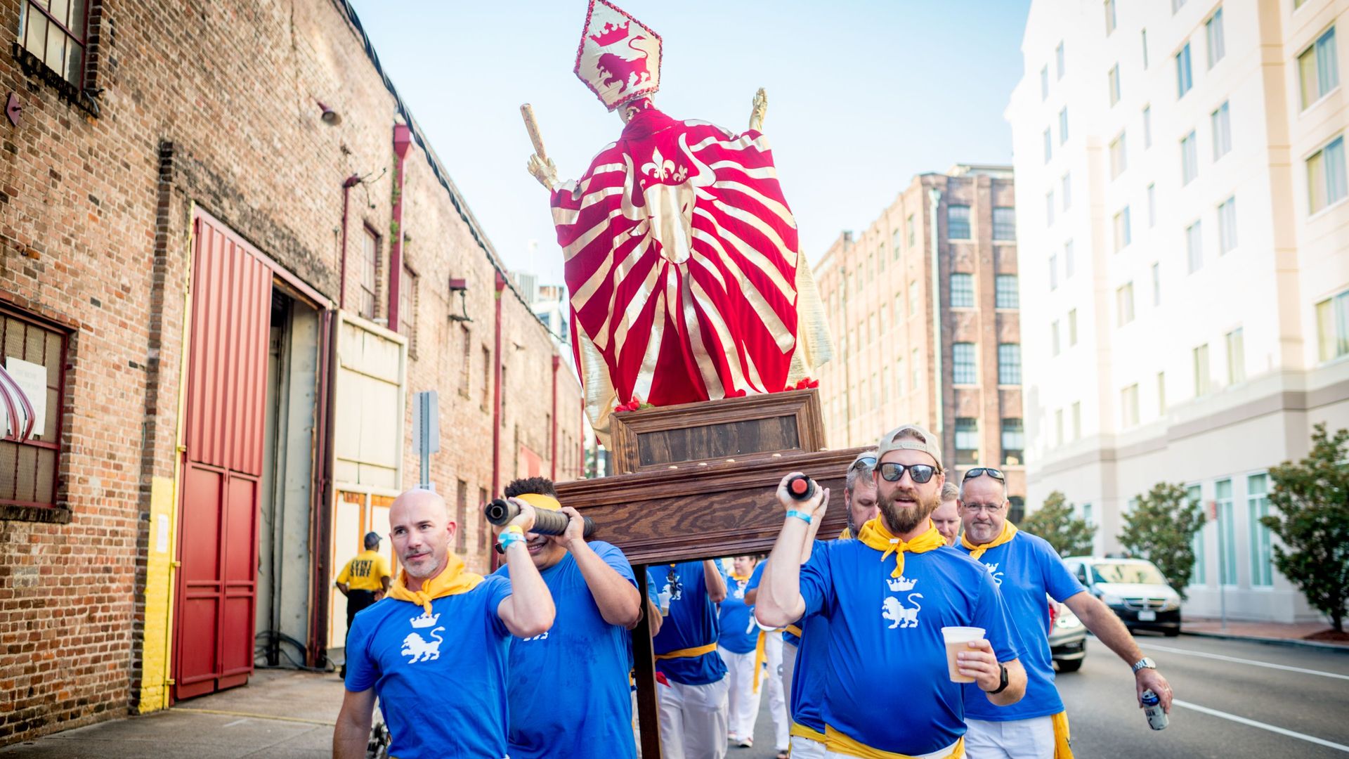 Image shows people carrying a statue of San Fermin through the streets of New Orleans.