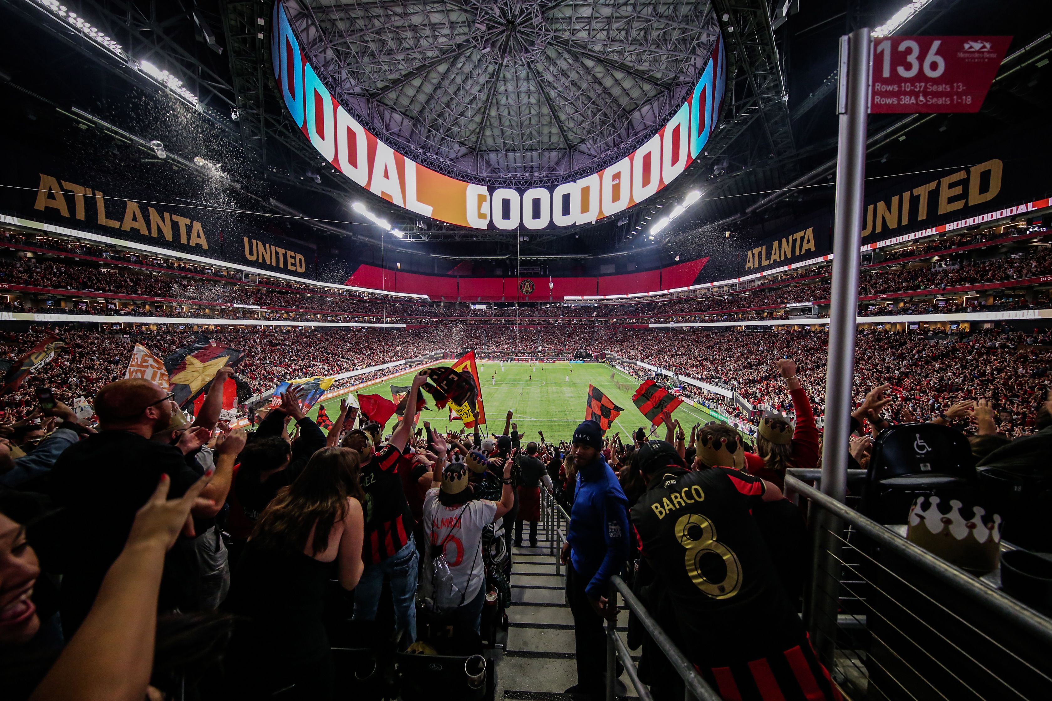 A zoomed back photo of a packed Mercedes-Benz Stadium during a home Atlanta United game