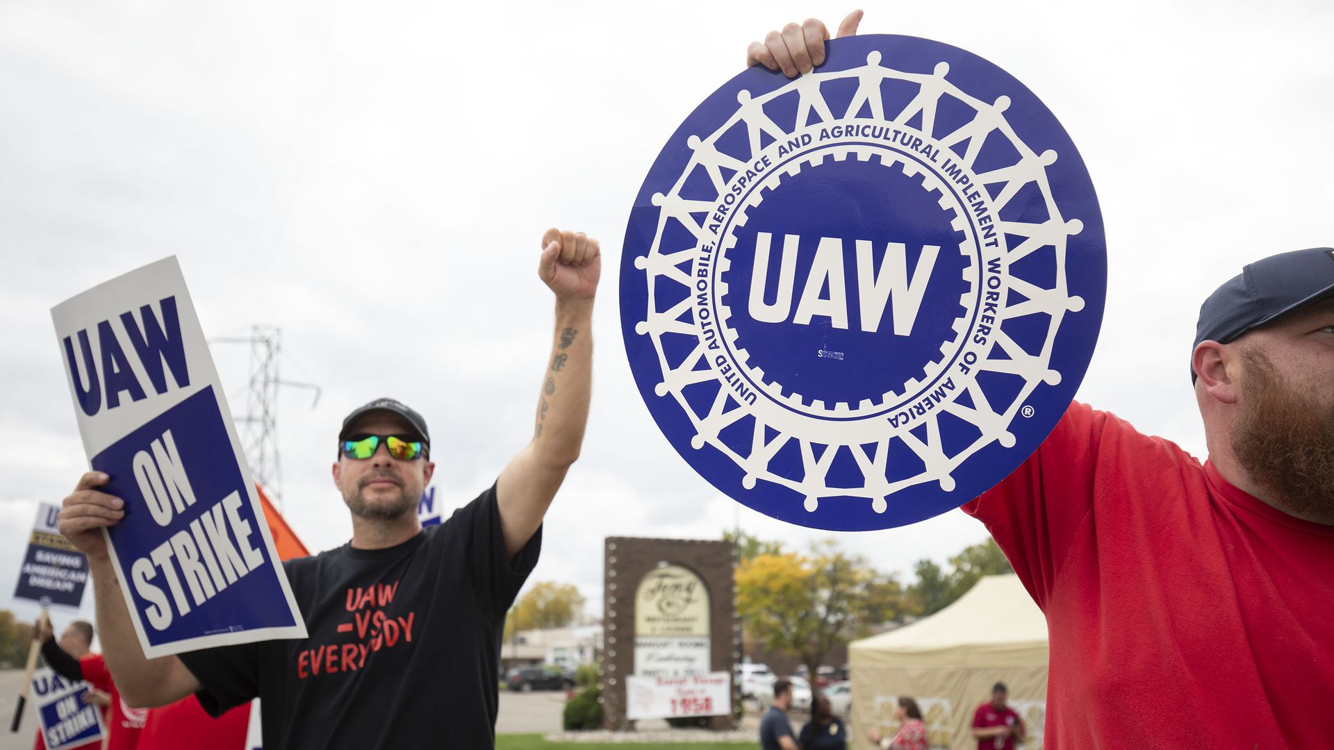 UAW workers holding up signs on a picket line