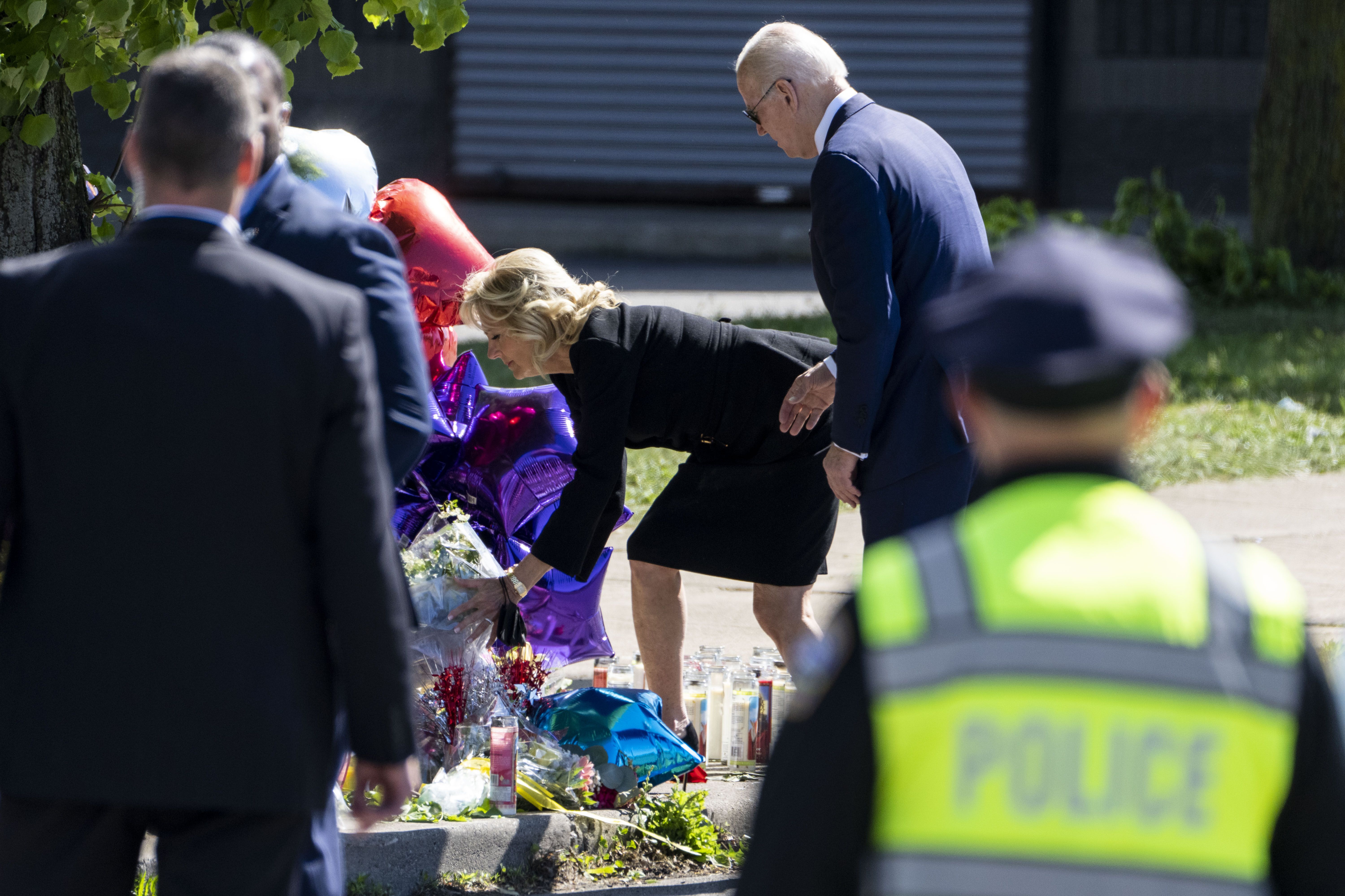 Jill Biden places flowers at a memorial just across the street of the Tops Friendly Market 