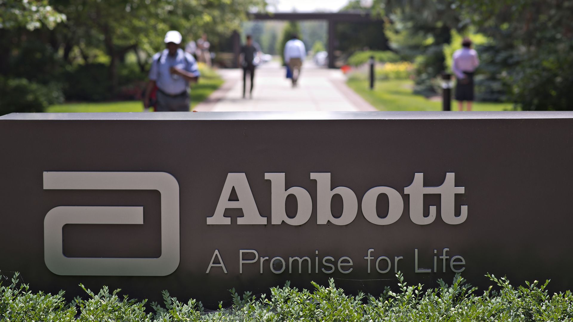 A dark Abbott Labs sign on the company's grassy headquarters.