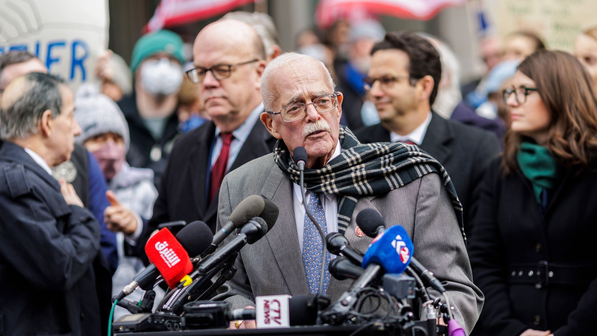 Rep. Gerry Connolly, wearing a gray suit and a scarf, speaks at a press conference outside surrounded by other Democratic lawmakers.