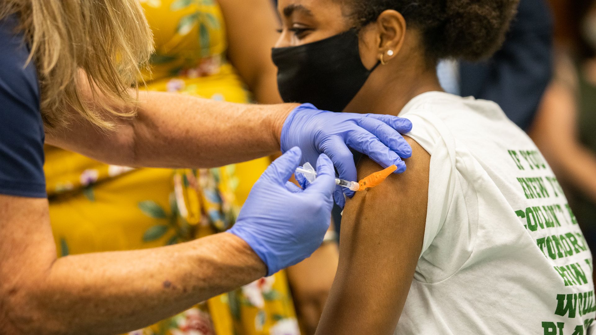 Picture of a health worker vaccinating a child