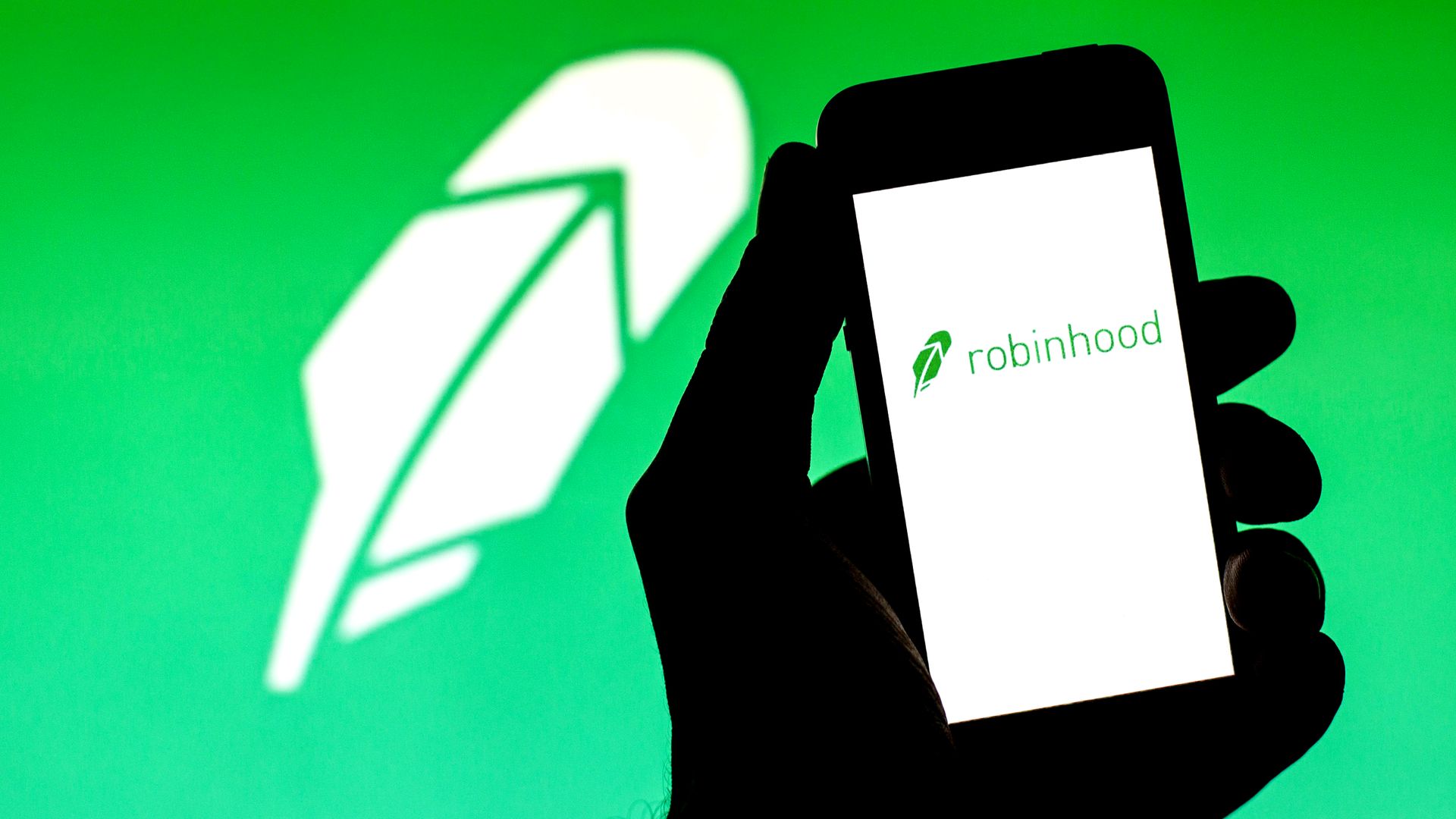 Someone holding a smartphone with the Robinhood app open