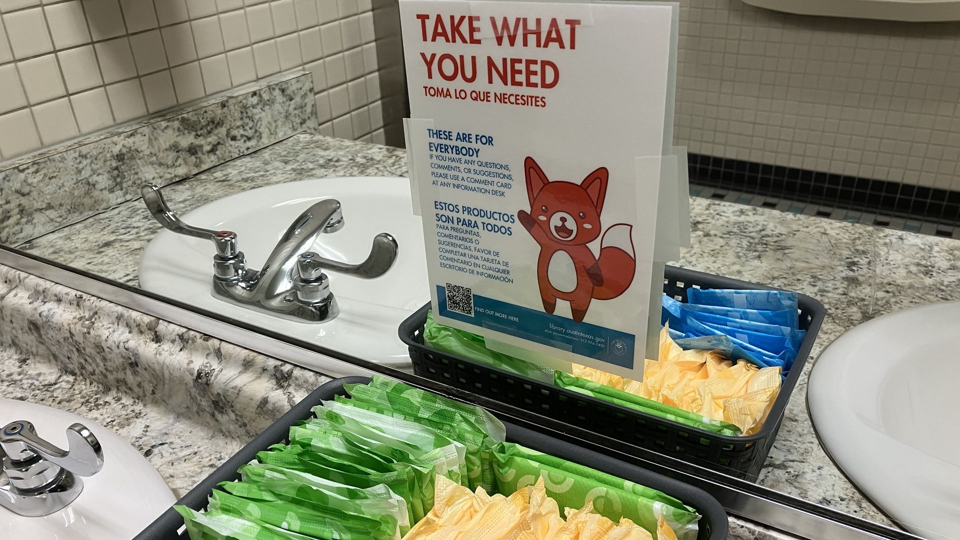 Menstrual products available for free in a bathroom at a library.