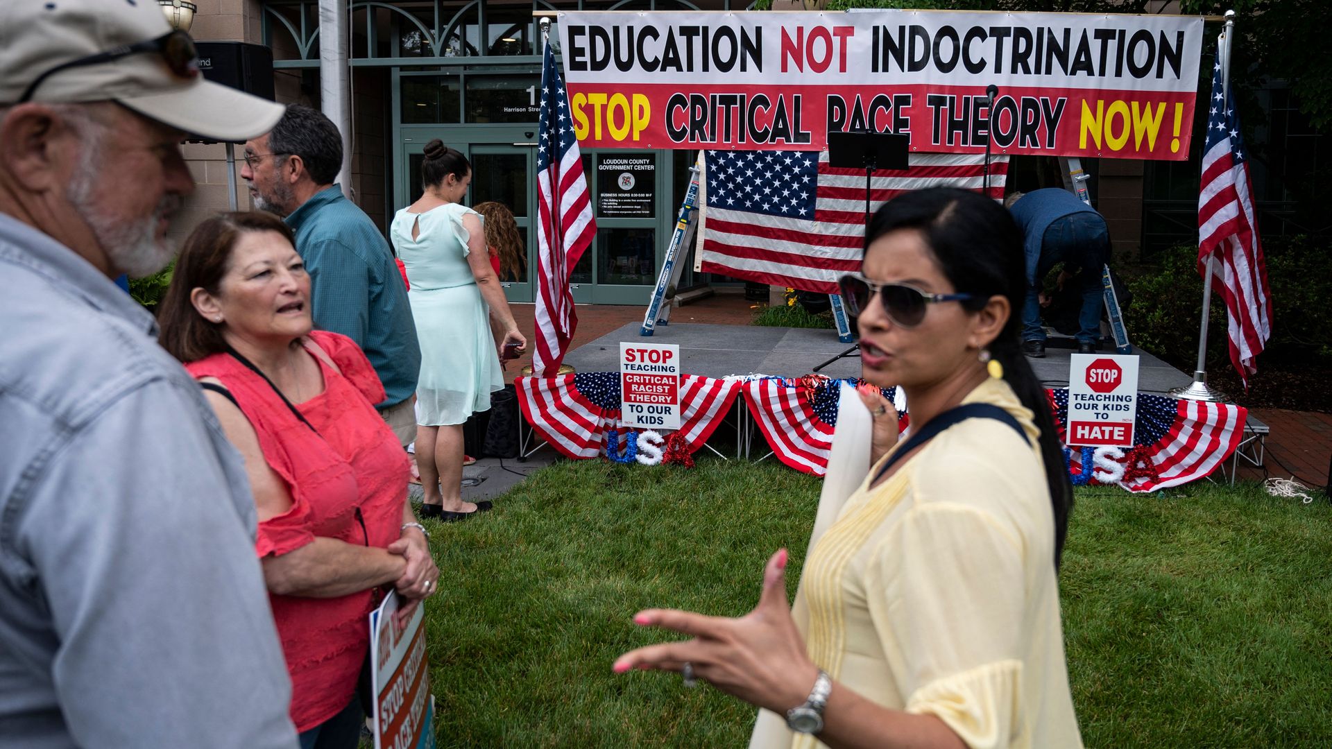 People talk before the start of a rally against "critical race theory" (CRT) being taught in schools at the Loudoun County Government center in Leesburg, Virginia.