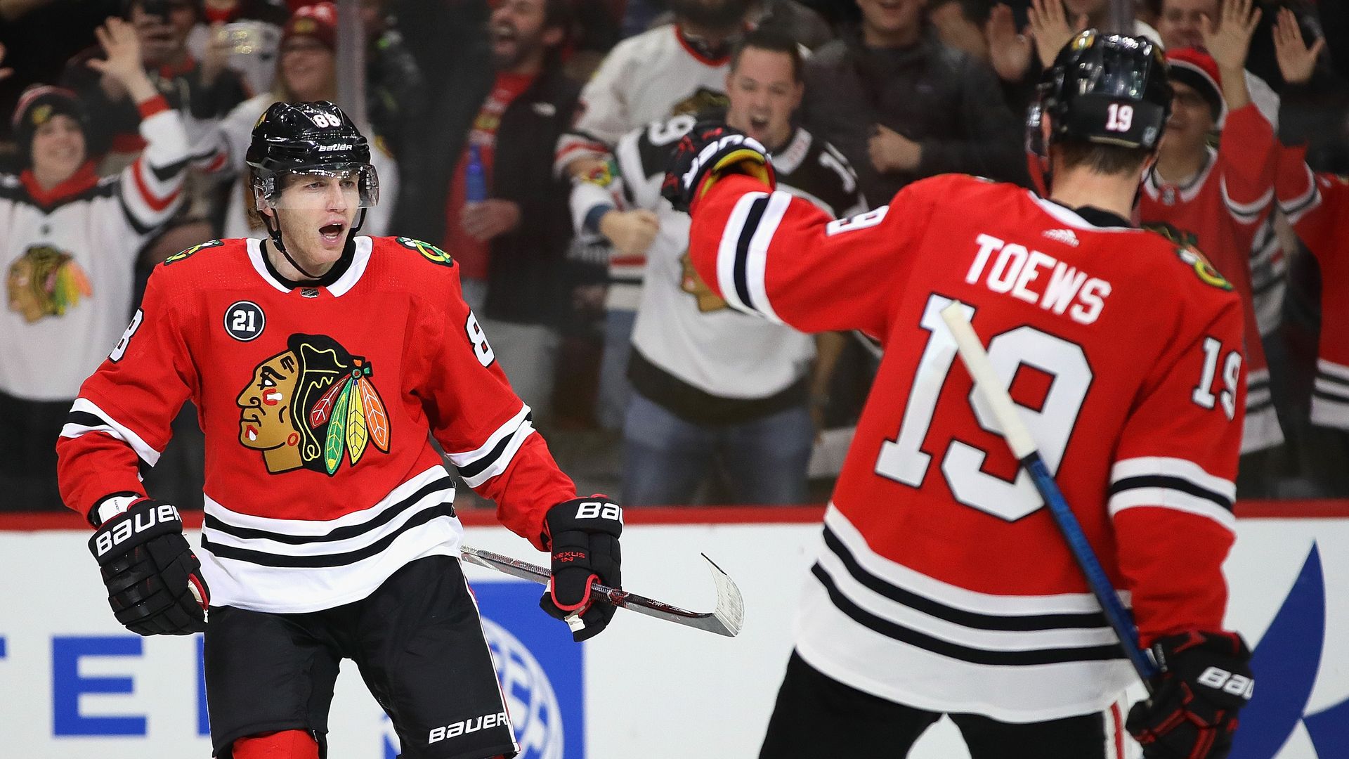 Photo of two hockey players on ice.