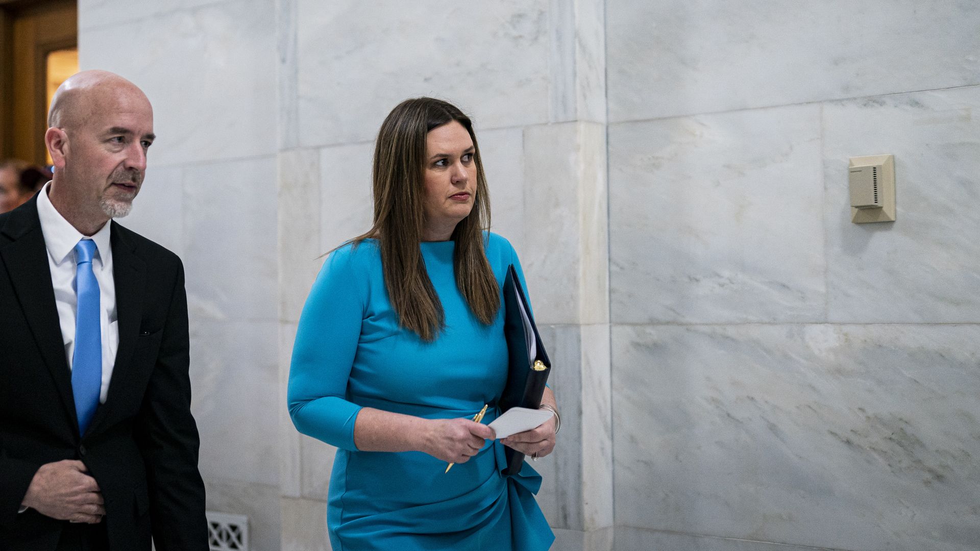 Sarah Huckabee Sanders, governor of Arkansas, right, walks with Jacob Oliva, Arkansas education secretary.