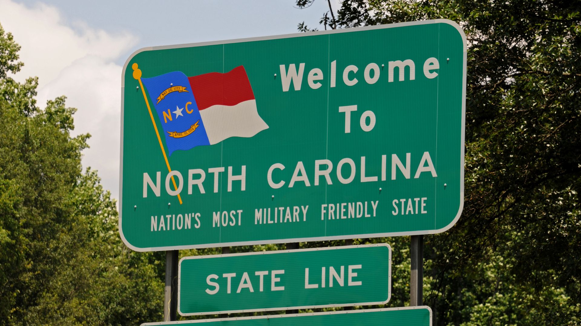 A "Welcome to North Carolina" sign.