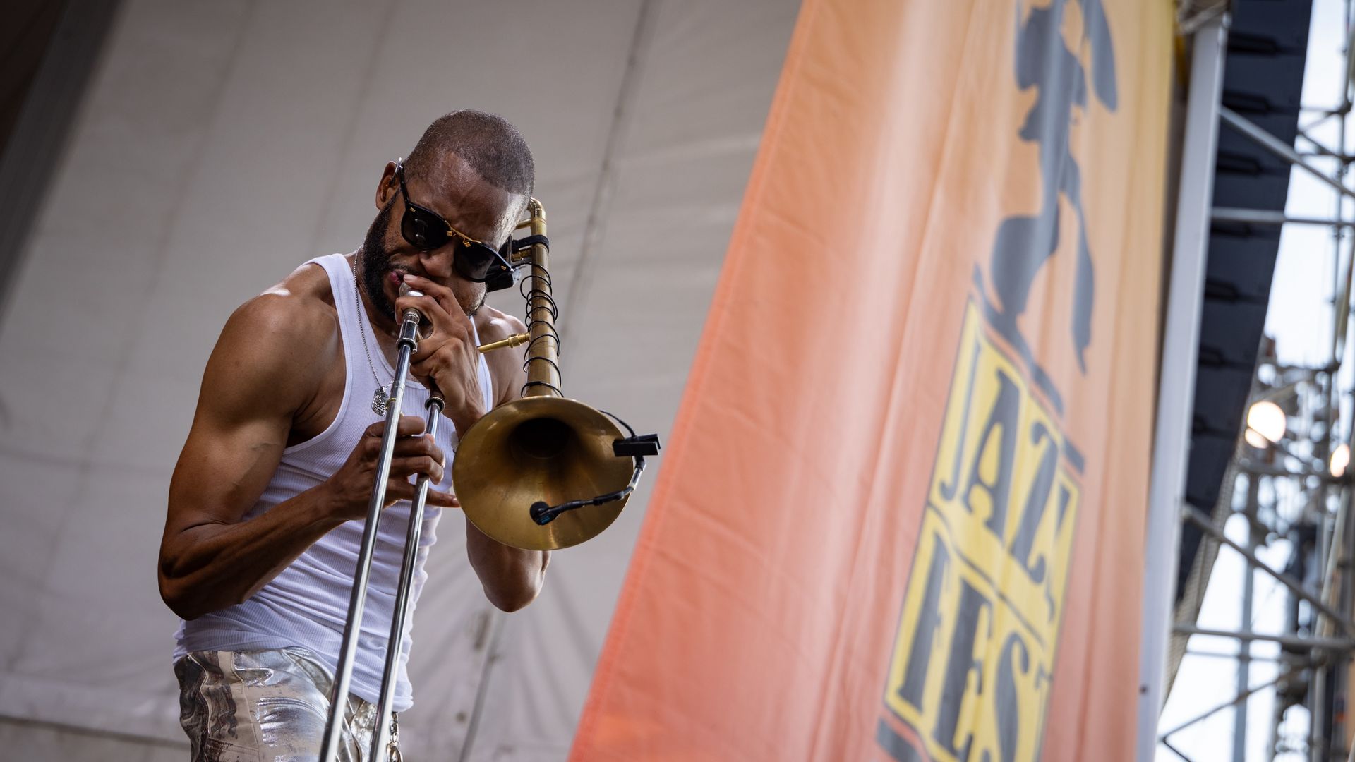 Trombone Shorty performs on stage at a jazz festival. 