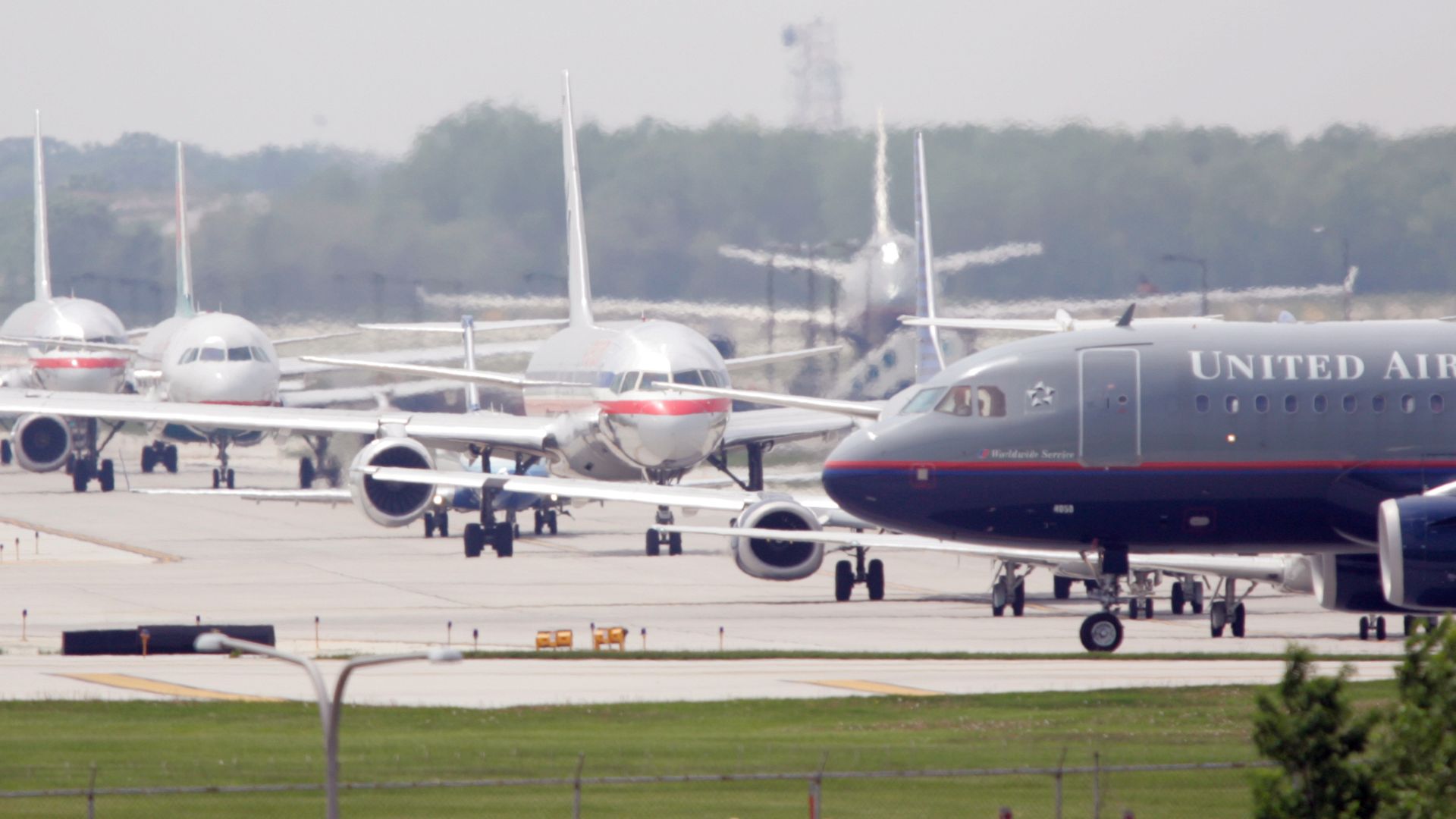Photo of airplanes taxiing on a runway. 
