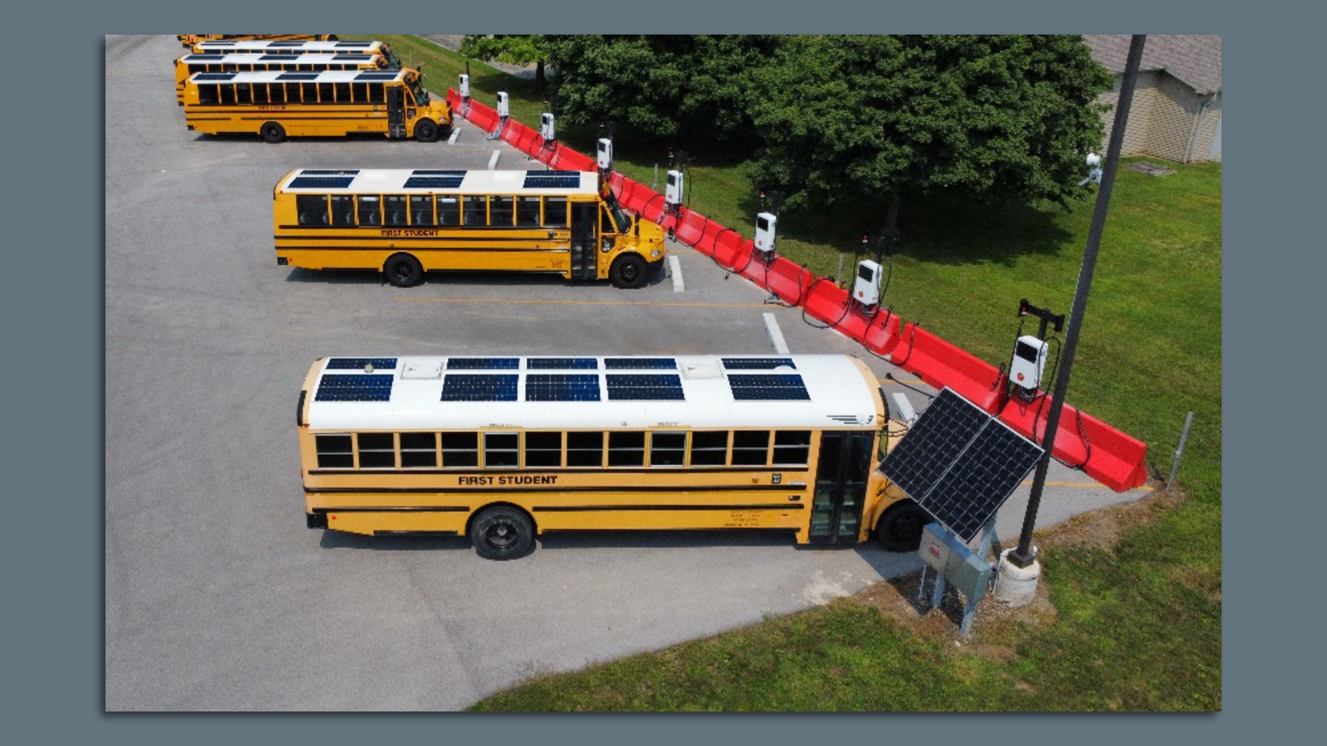 Image of yellow school buses with solar panels on the roof. 