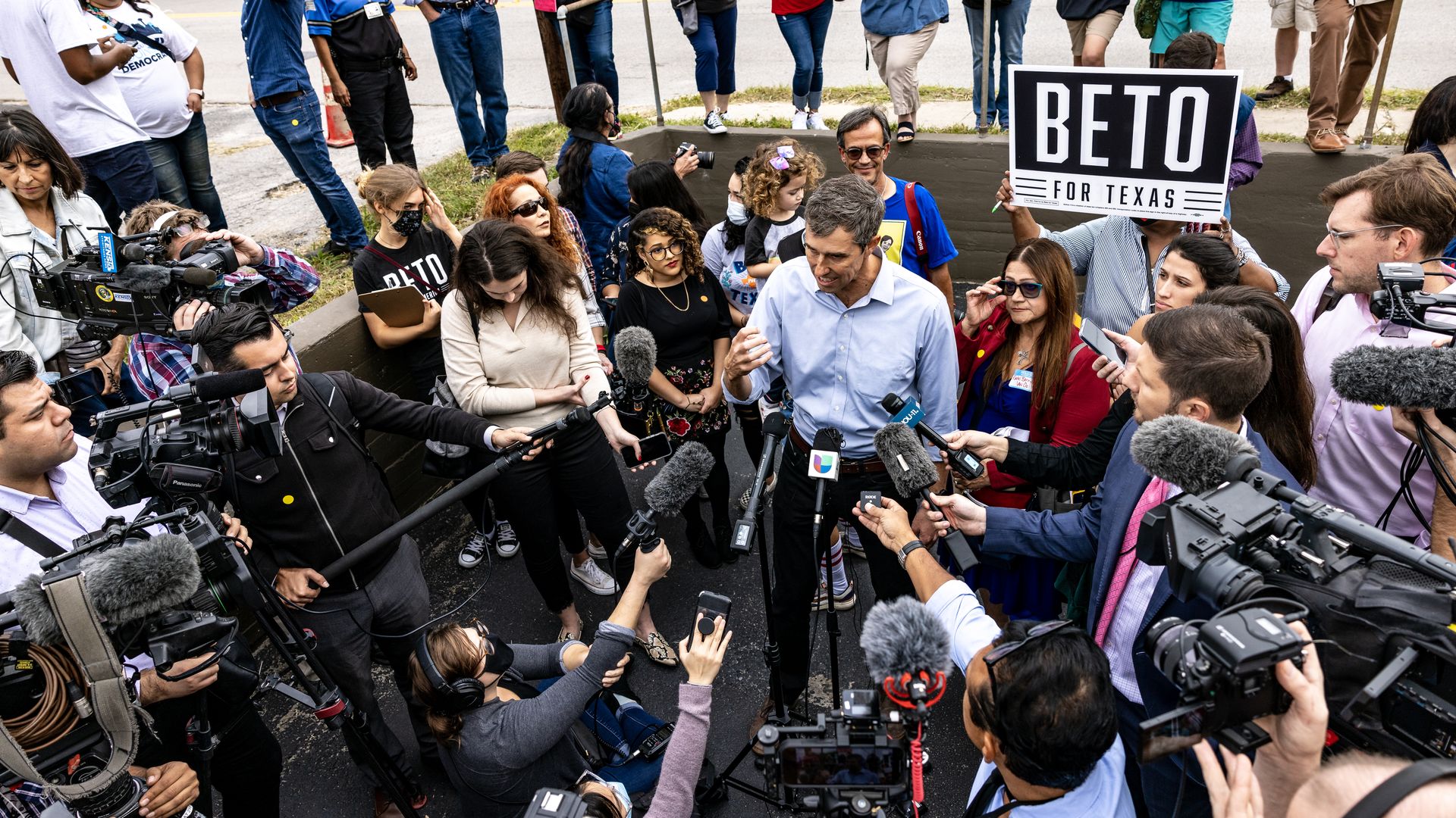Beto surrounded by cameras and microphones