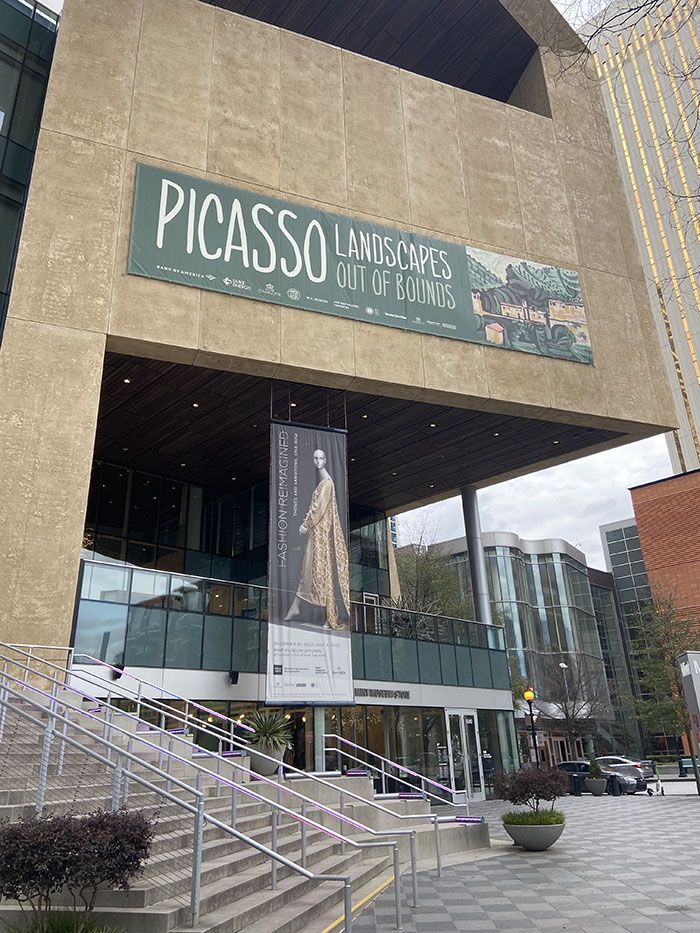 A banner for "Picasso Landscapes: Out of Bounds" hangs outside the Mint Museum Uptown.