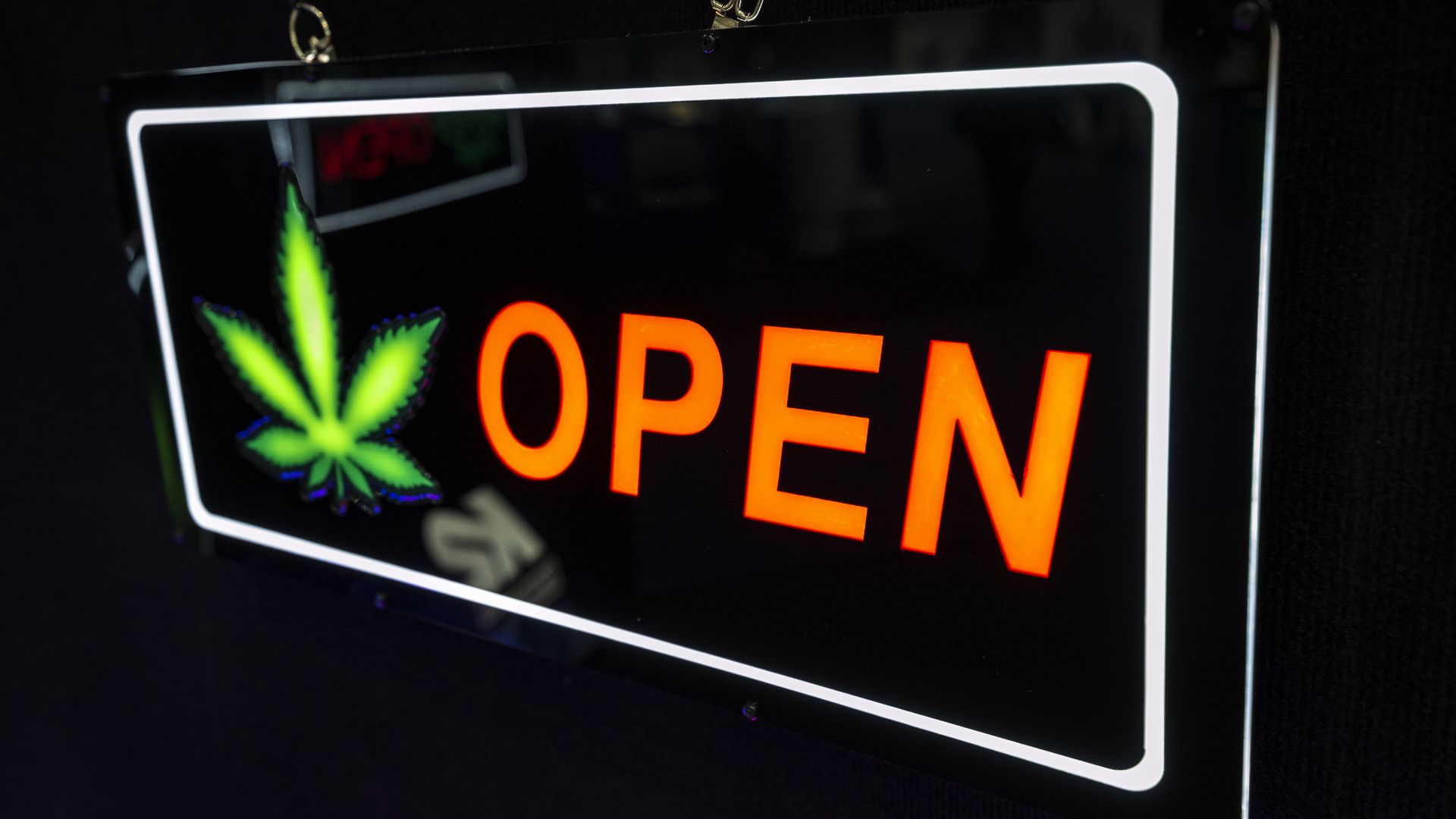 An open side with a neon marijuana leaf