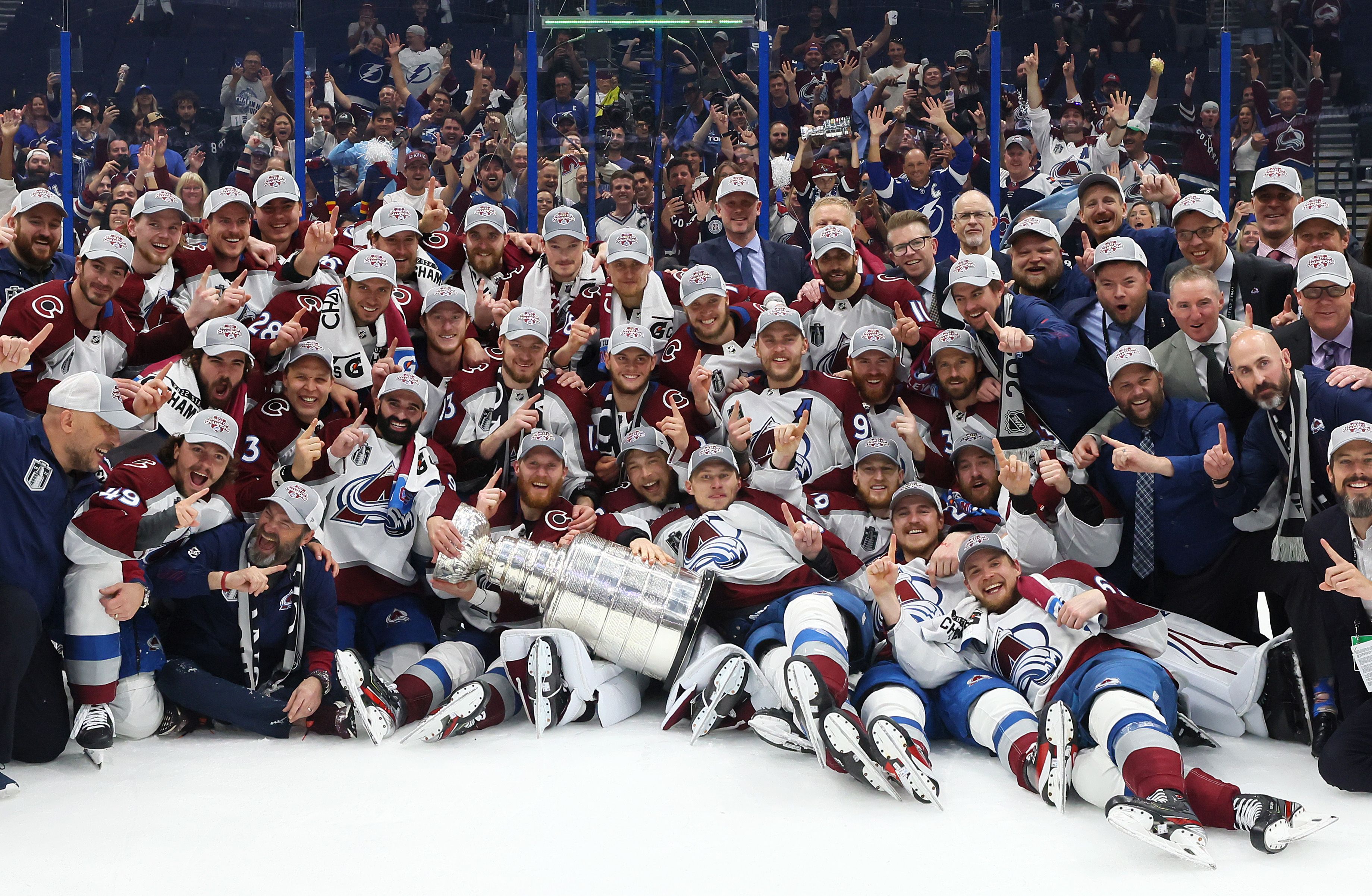  Colorado Avalanche coaches and players pose for a photo after defeating the Tampa Bay Lightning 2-1 in Game Six of the 2022 NHL Stanley Cup Final.