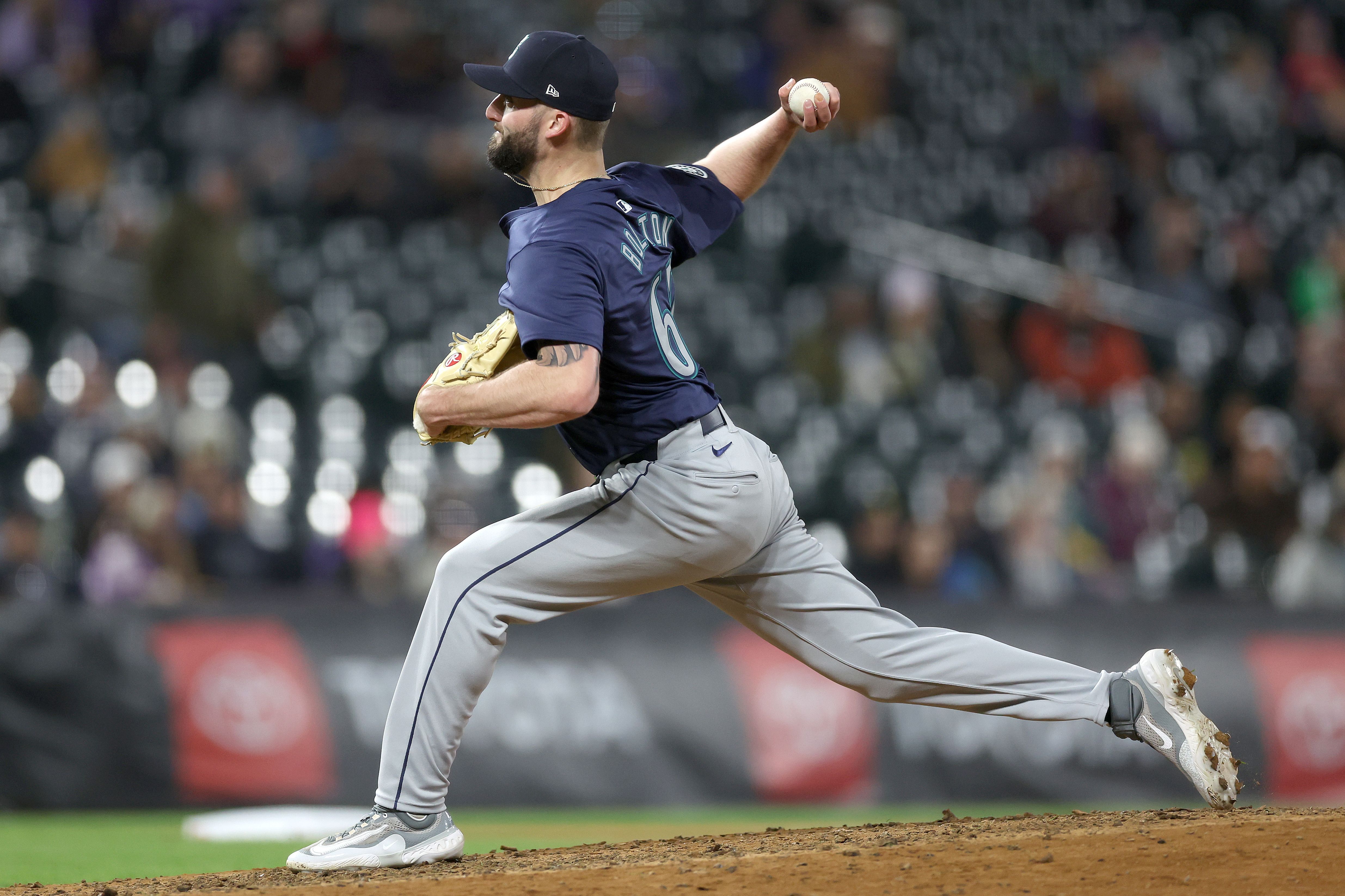 A Seattle Mariners pitcher throws a ball during the second game of a double header against the Rockies. 