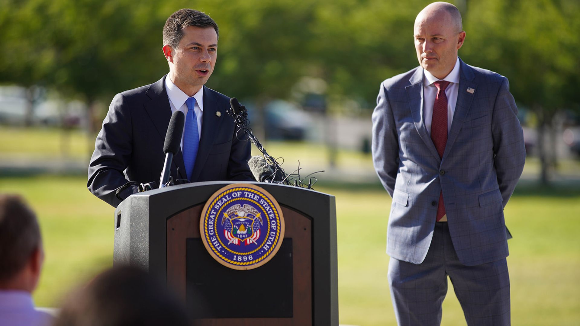 Transportation Secretary Pete Buttigieg speaking behind a podium.