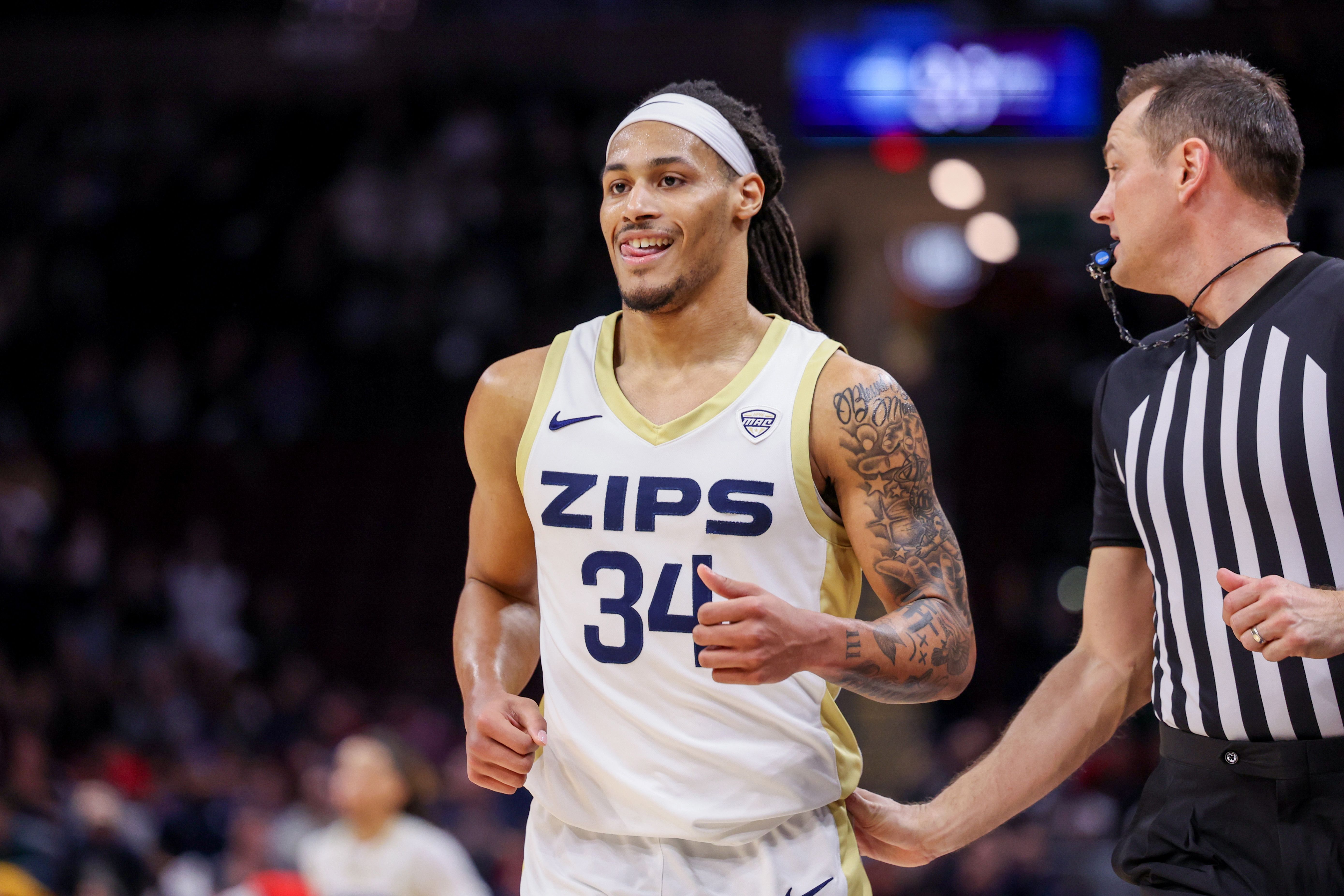Photo of a basketball player on a court with a jersey that says "ZIPS" 