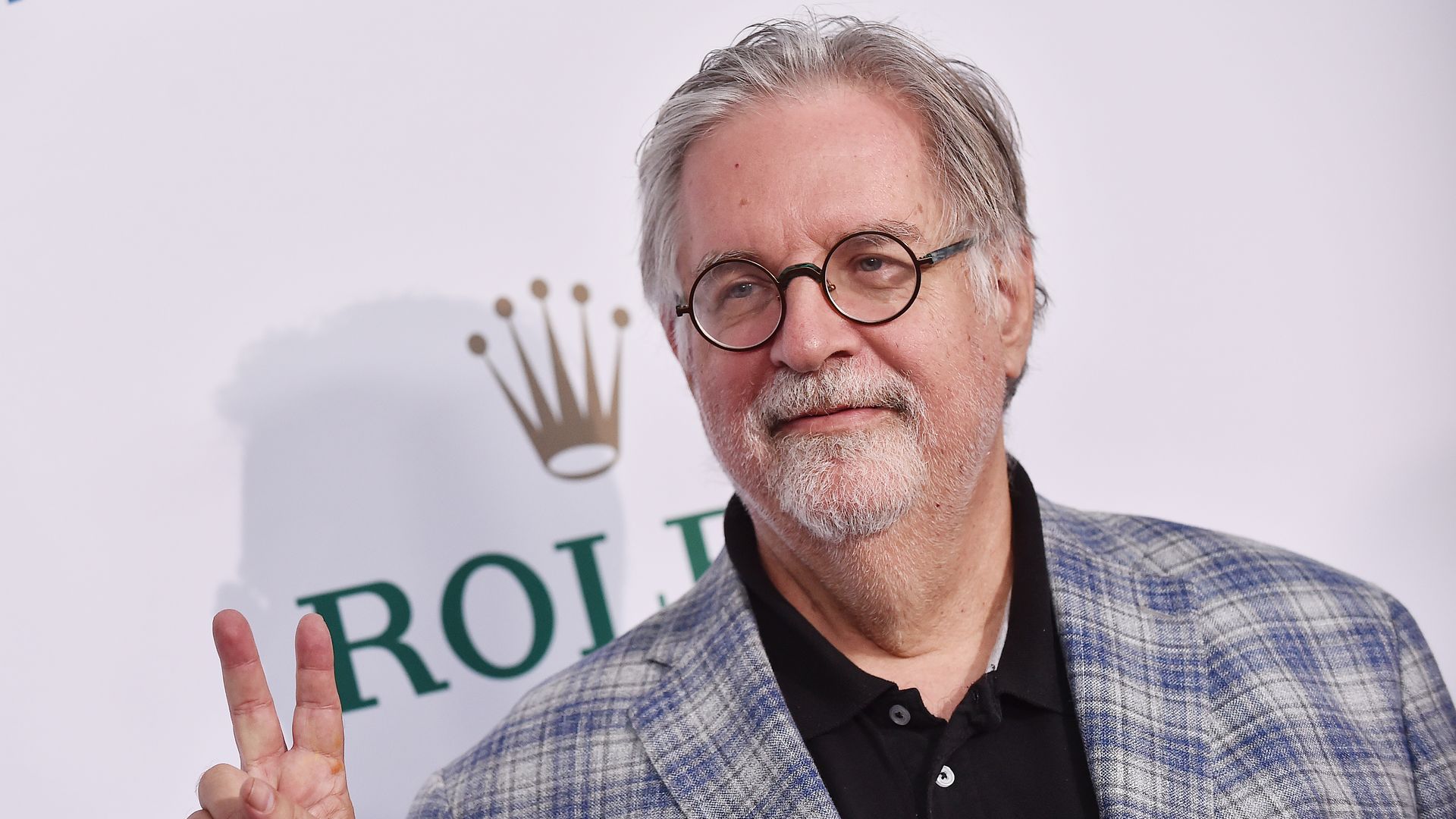 A photo of a person holding the peace sign.