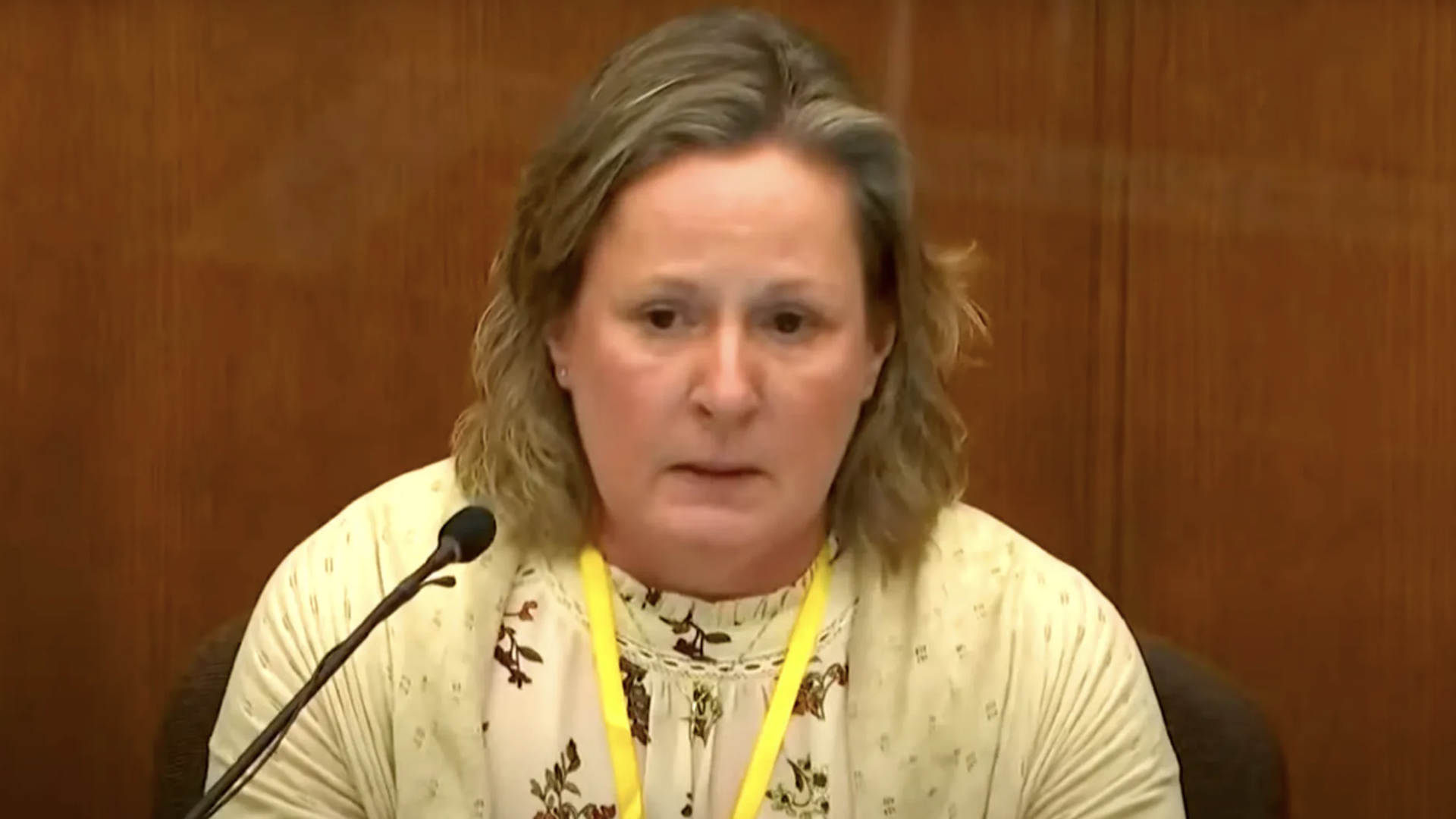 Kim Potter testifying in court with a yellow sweater