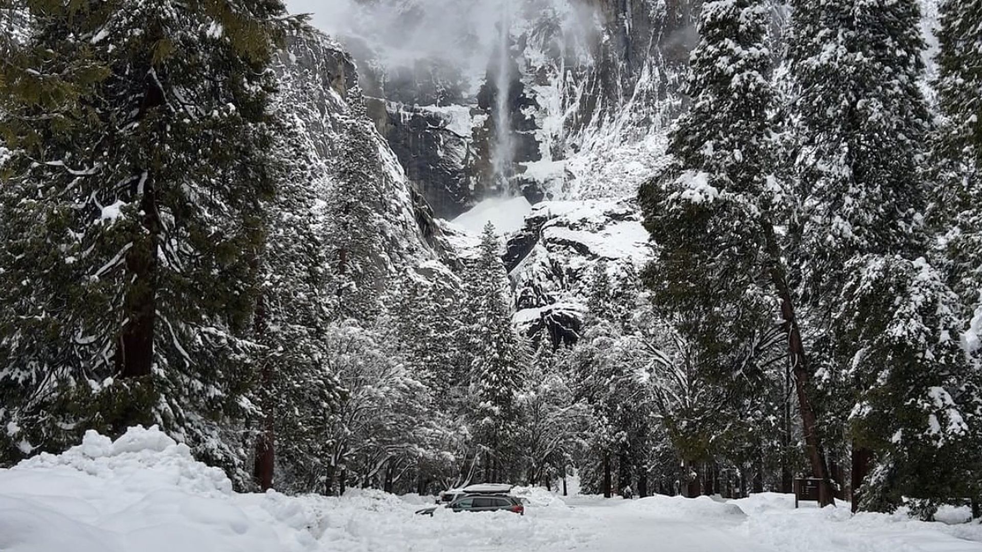 A screenshot of a Yosemite National Park tweet of a car buried in snow.