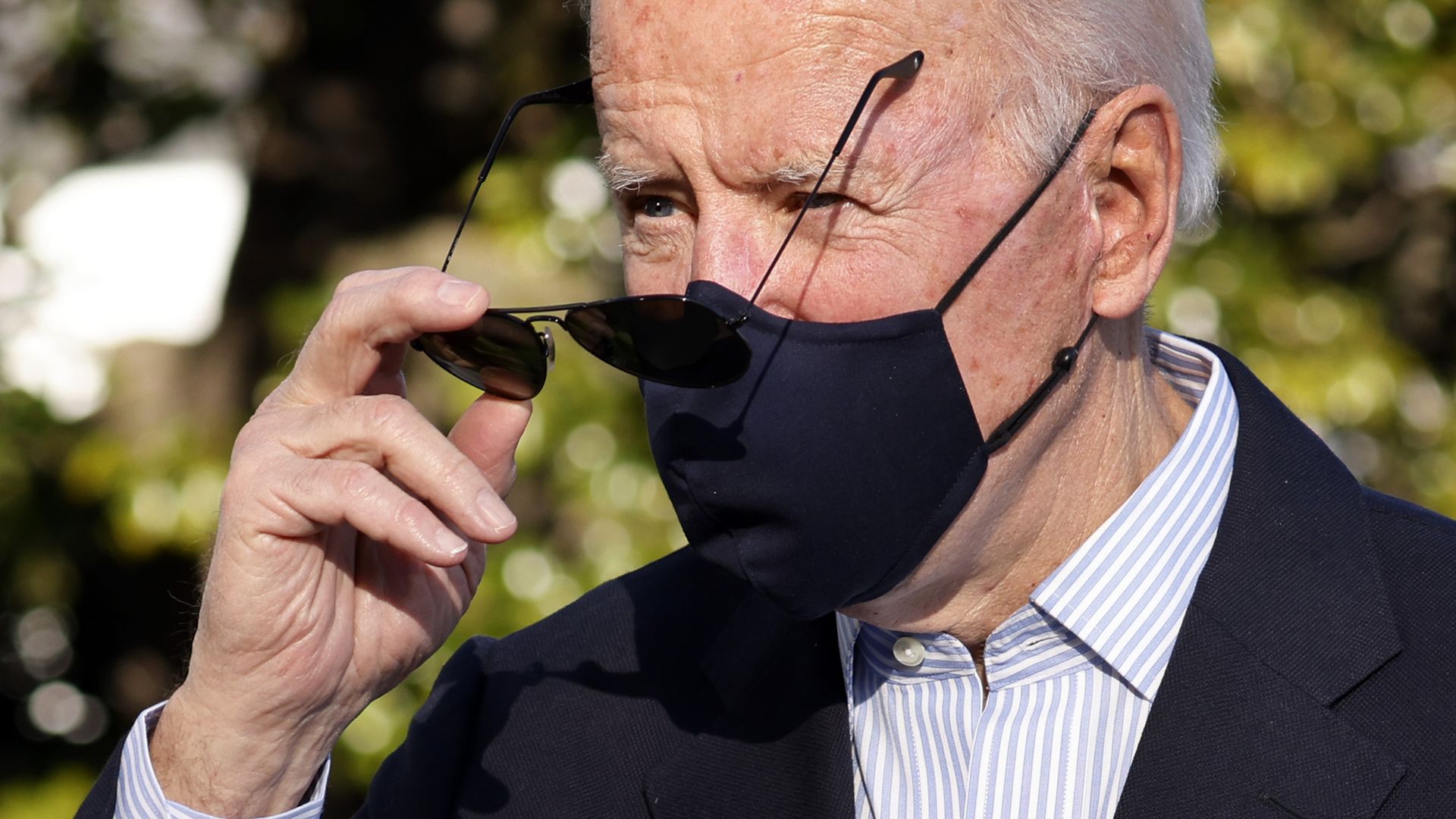 President Biden is seen removing his sunglasses as he returns from Camp David.