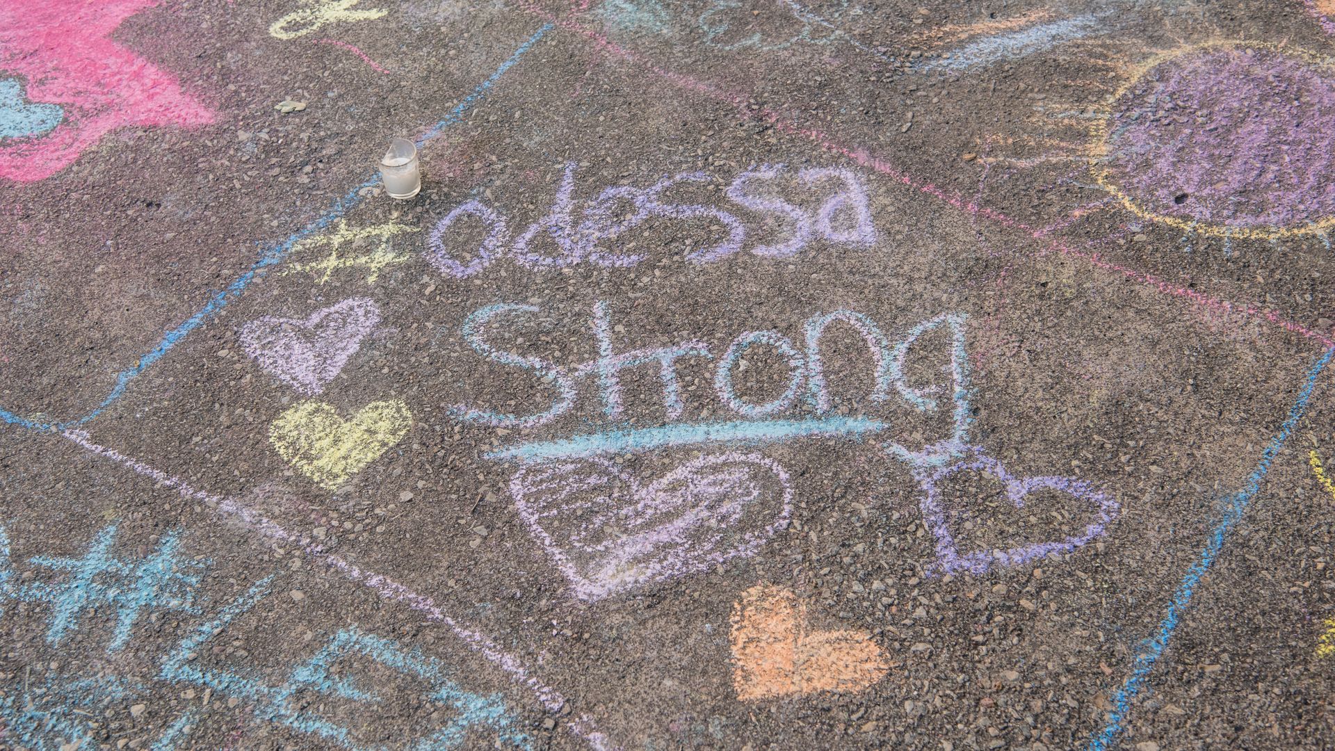 A chalk message on a sidewalk says Odessa Strong