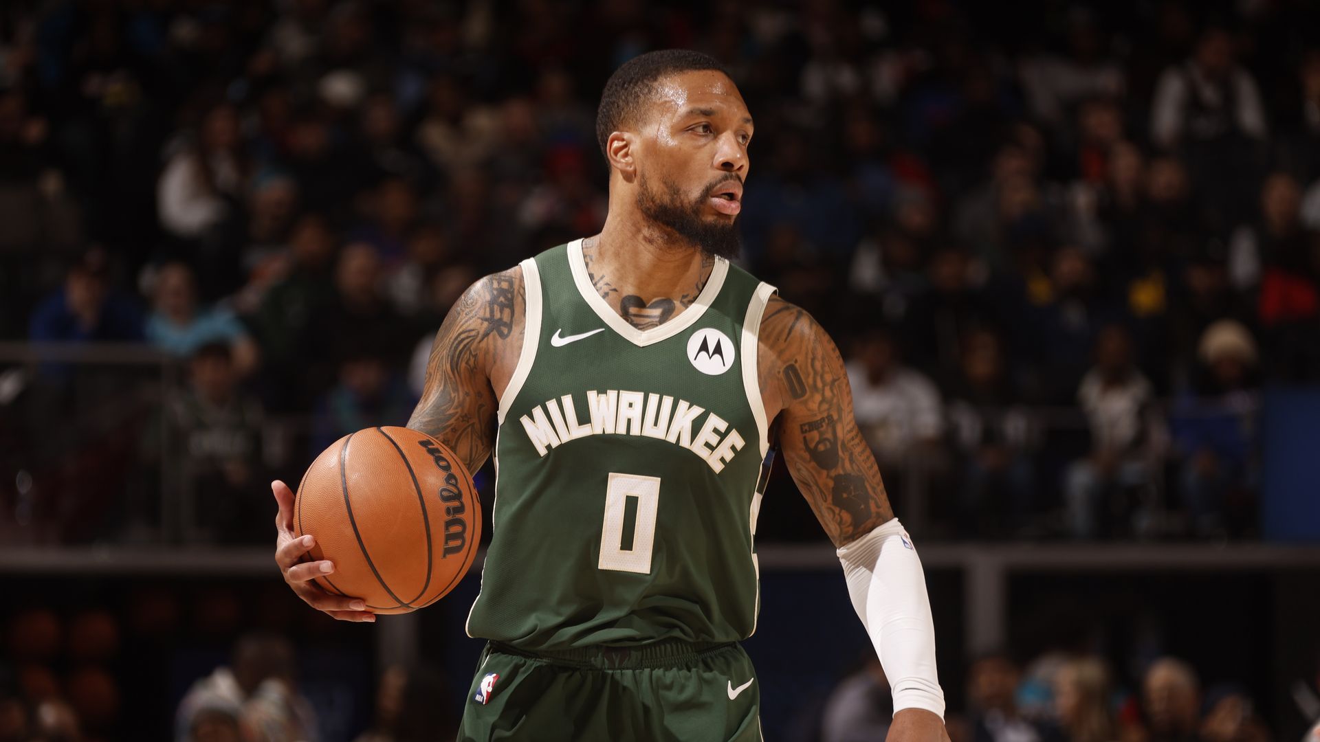 Damian Lillard of the NBA's Milwaukee Bucks holding a basketball in his right hand.