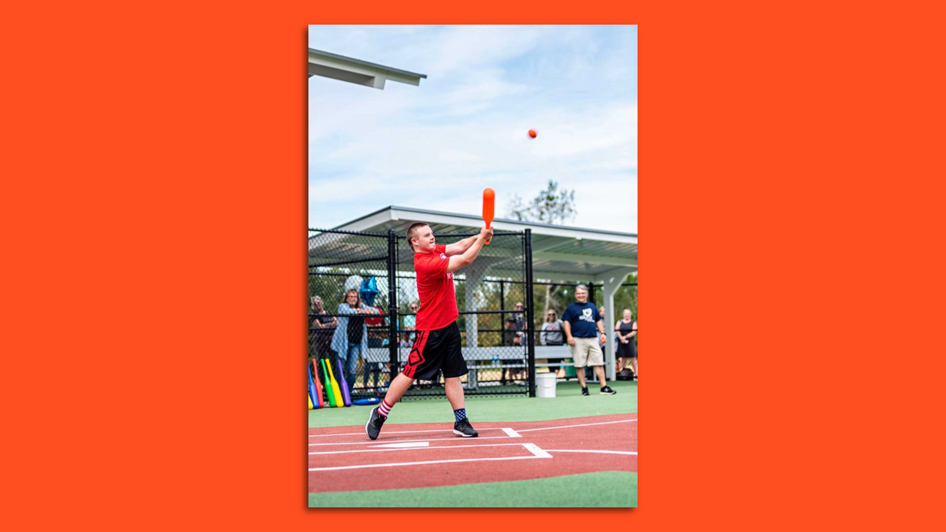 A young boy hits a baseball during a Miracle League game.