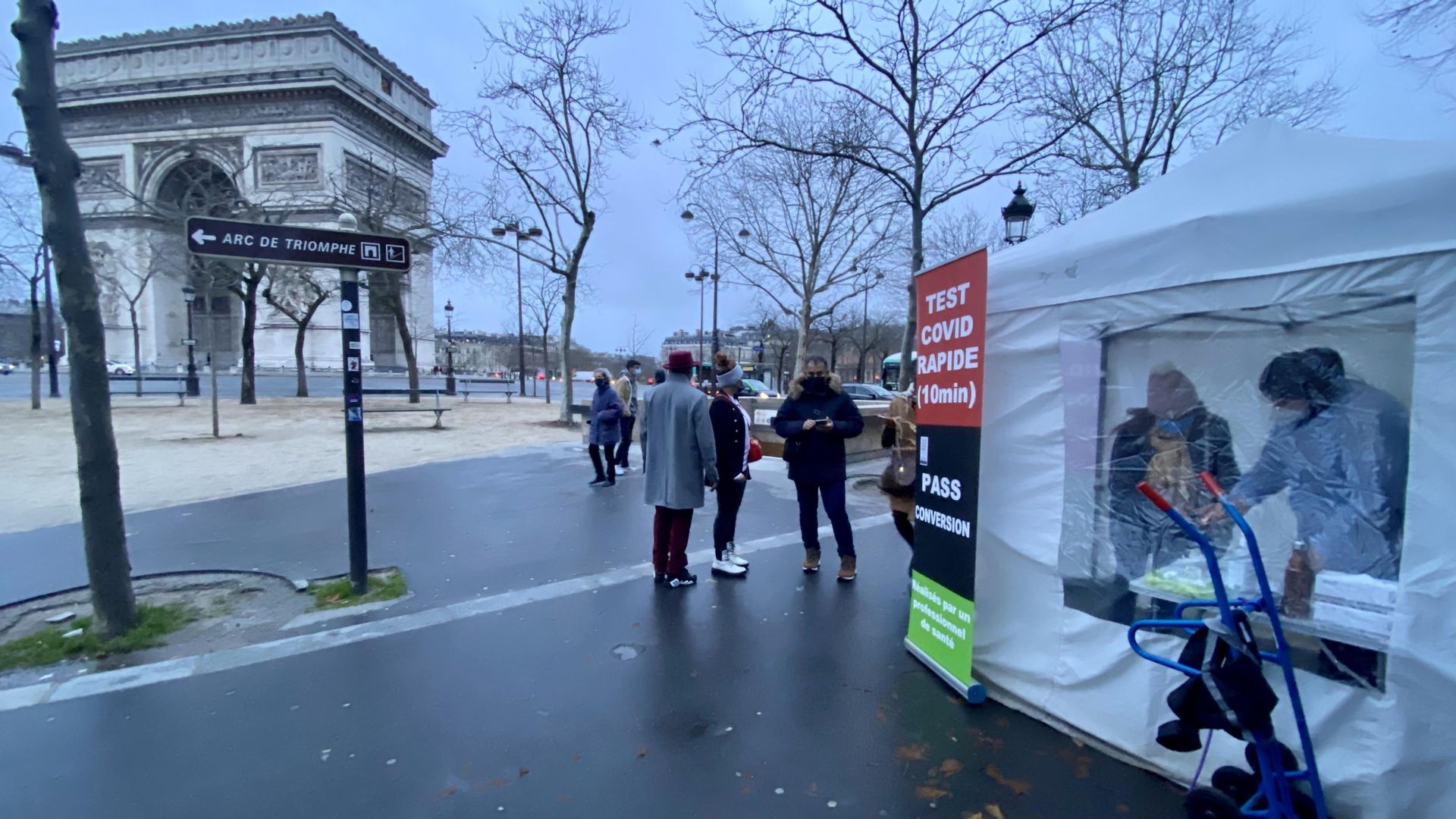 A technician in PPE performs COVID tests next to the Arc de Triomphe in Paris this morning.