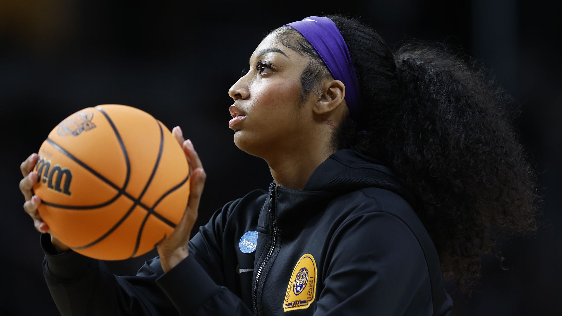 Photo shows Angel Reese with a basketball