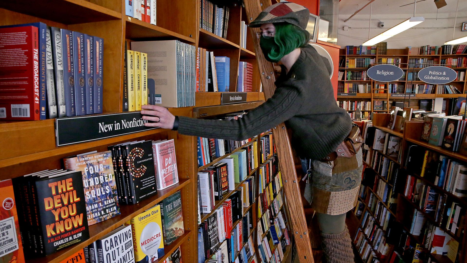 A bookstore worker stocking shelves.