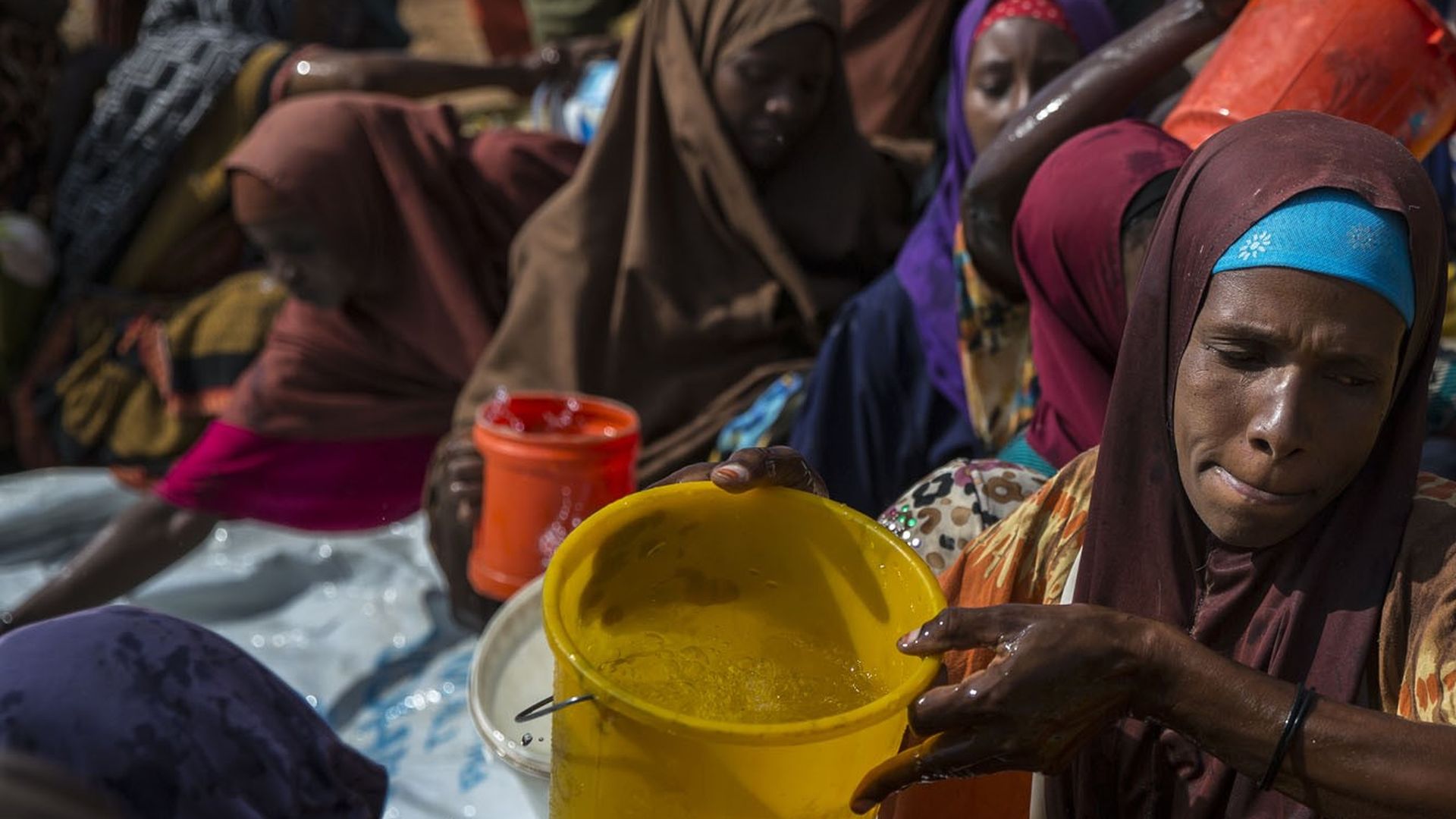Somalians receive water as extreme drought threatens to leave many people hungry and vulnerable to disease epidemics, in Bay, Somalia on April 2, 2017