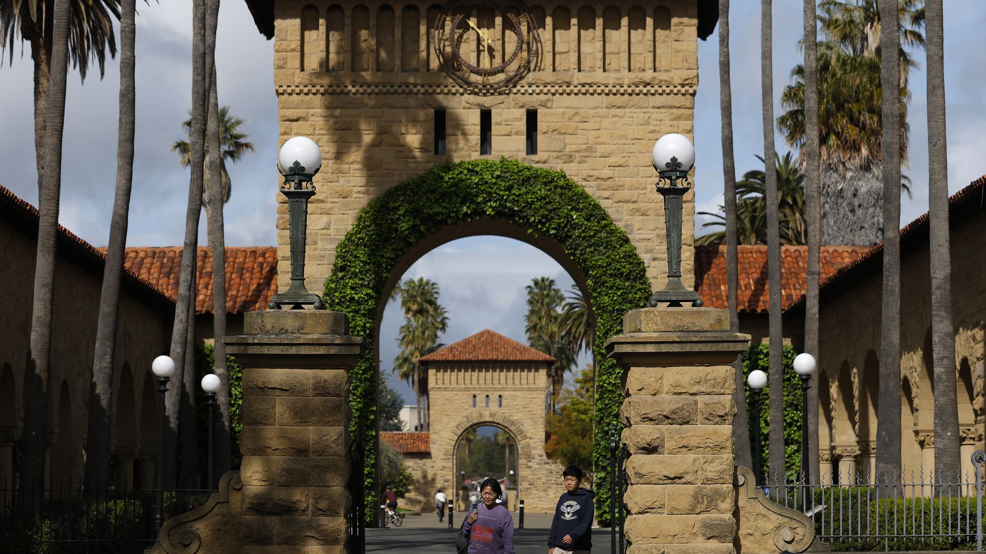 STANFORD, CALIFORNIA - MARCH 28: Pedestrians walk on the Stanford University campus on March 28, 2025 in Stanford, California. U.S. Attorney General Pam Bondi is launching a compliance review investigation into admissions policies at Stanford University and several University of California Schools a