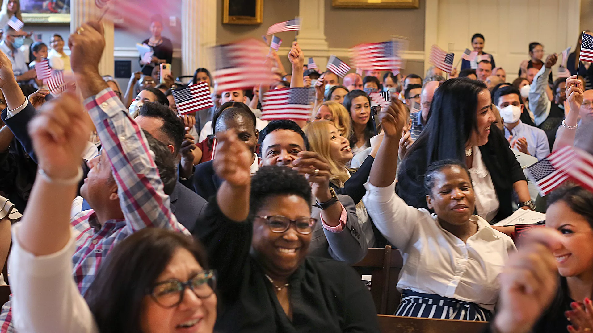 A group of people waving American flags.