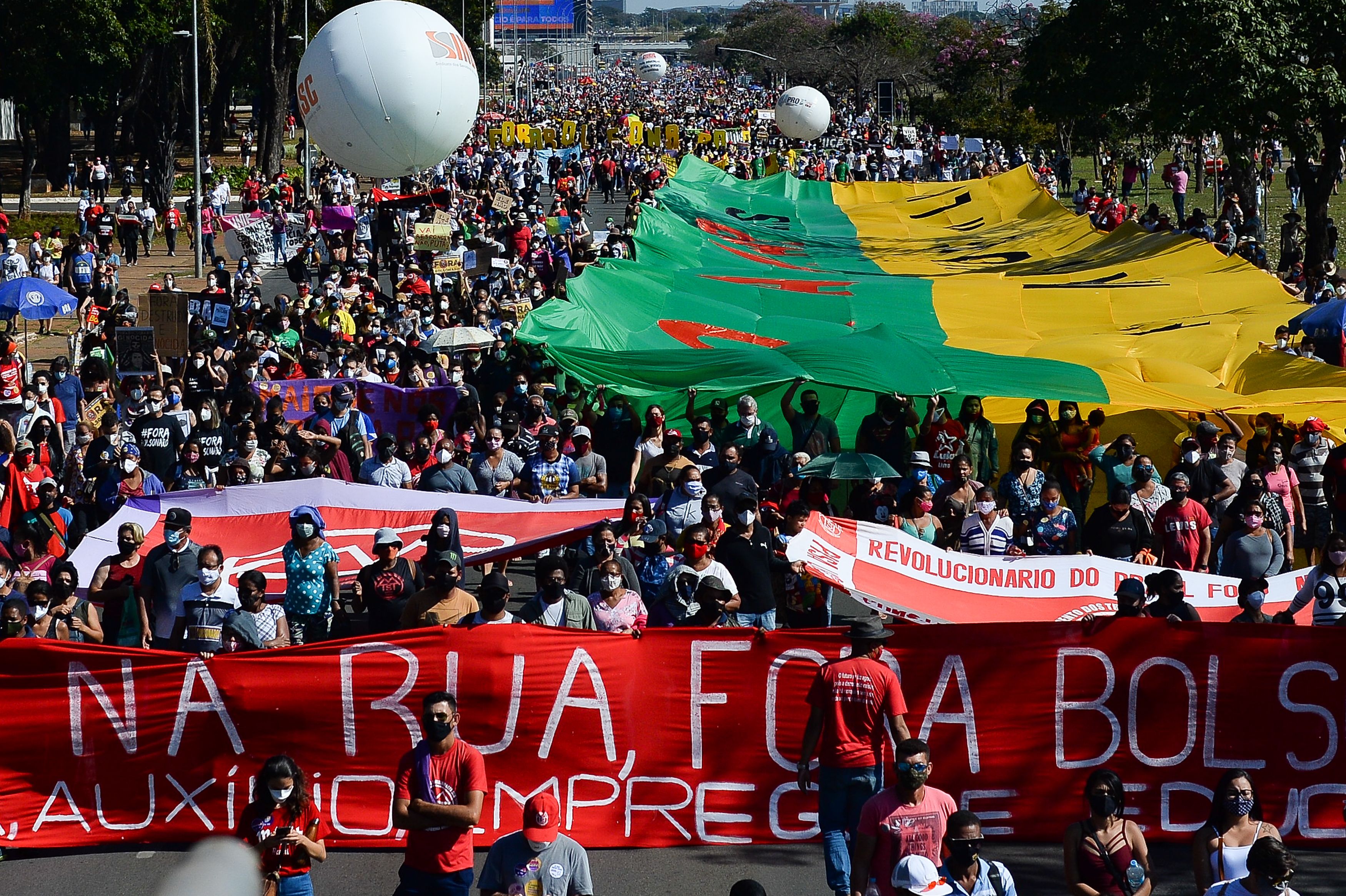  Demonstrators gather holding large flags during a protest against Bolsonaro's administration on June 19, 2021 in Brasilia, Brazil