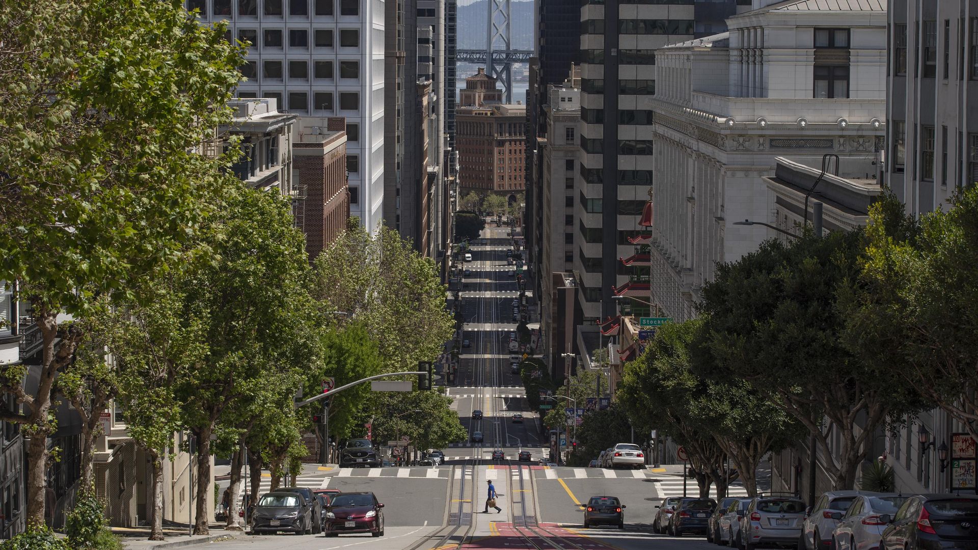 A man crosses an empty street in San Fransisco amid the coronavirus outbreak in April 2020