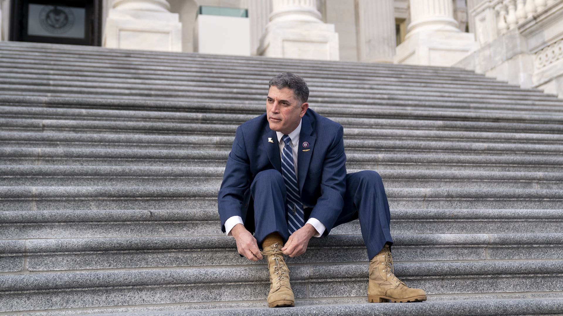 Andrew Clyde laces combat boots on steps of U.S. Capitol