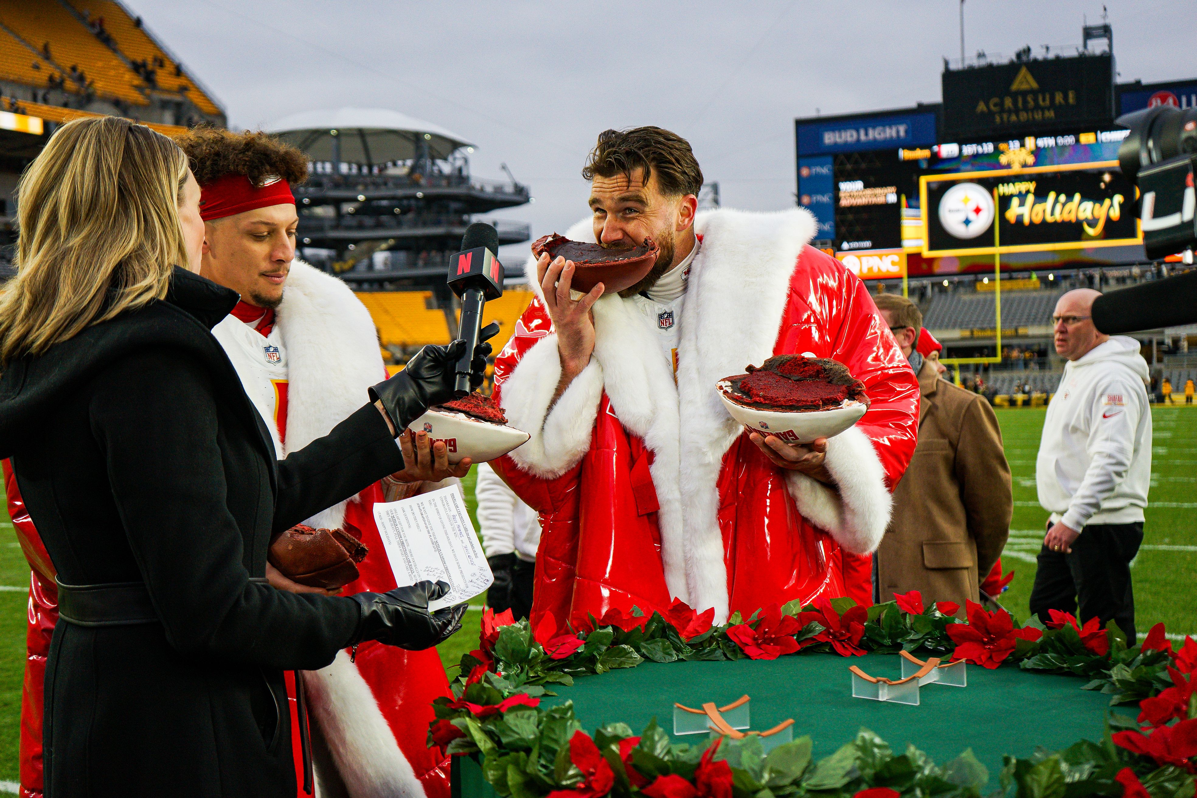 Kansas City Chiefs tight end Travis Kelce eats a football cake after a win over the Pittsburgh Steelers yesterday.