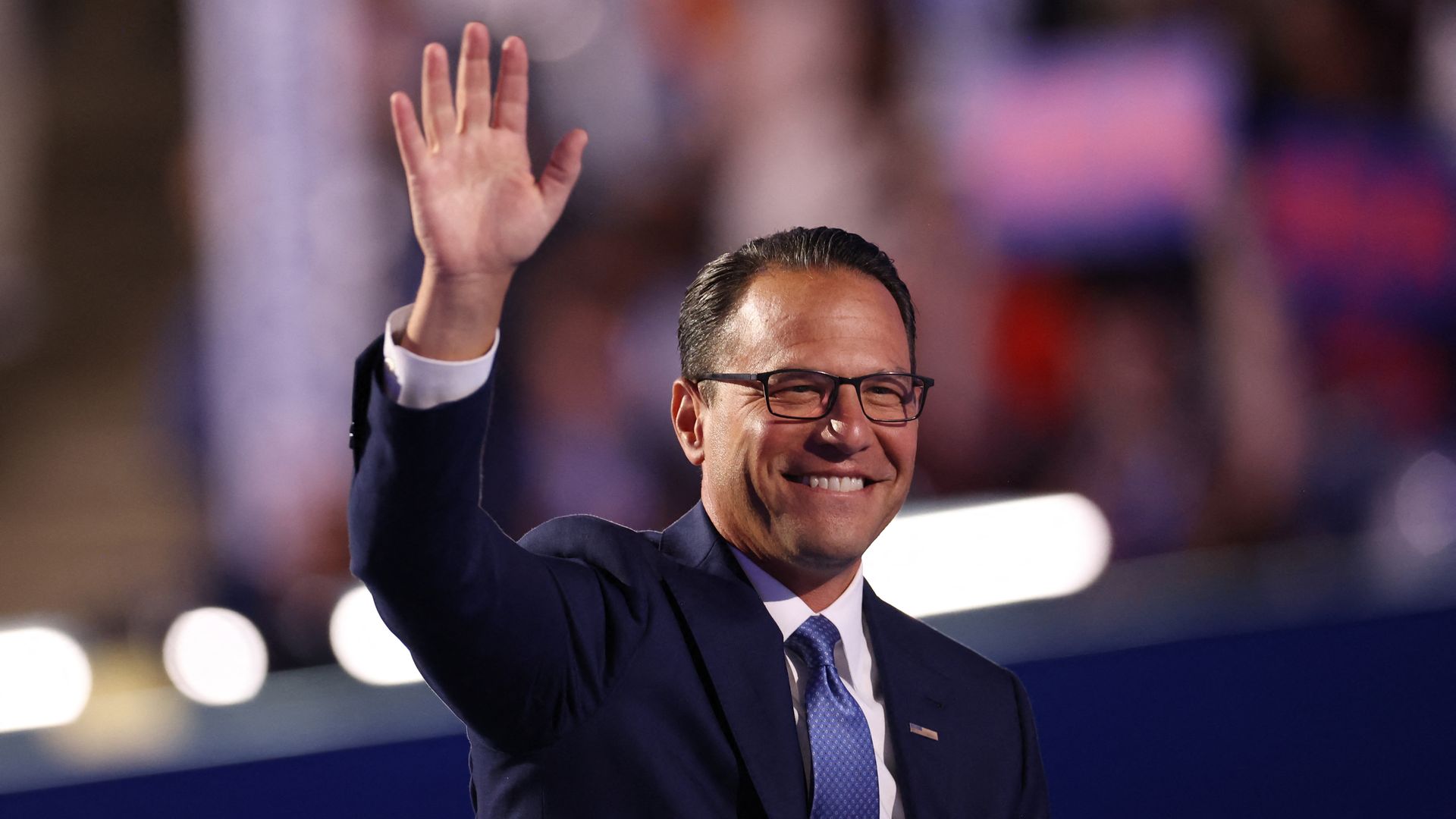 Gov. Josh Shapiro waves to the crowd on stage at the DNC.