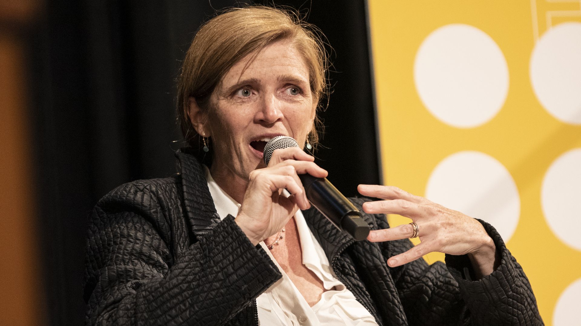 Samantha Power speaks into a microphone 