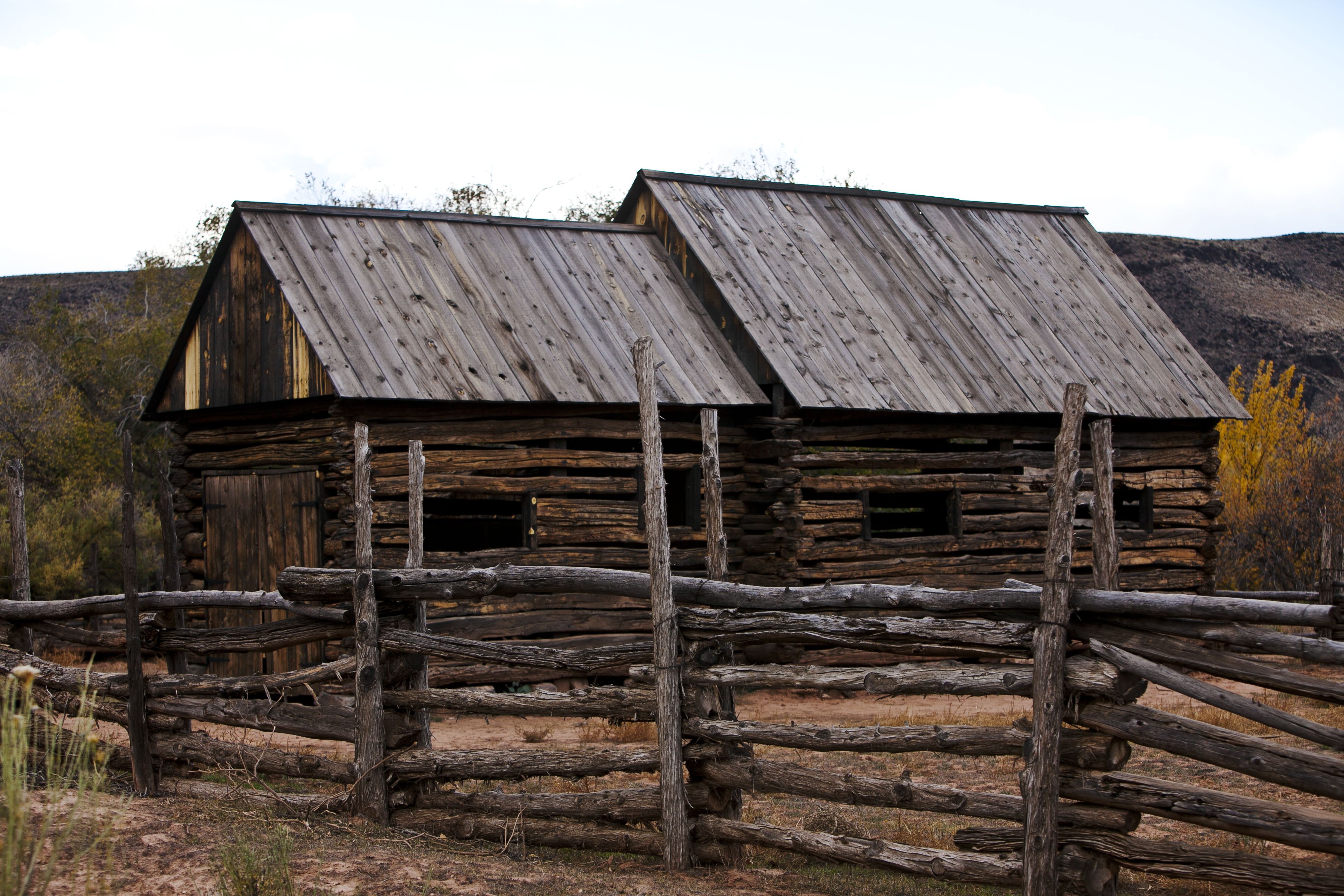 A cabin and wood pole fence in the desert.