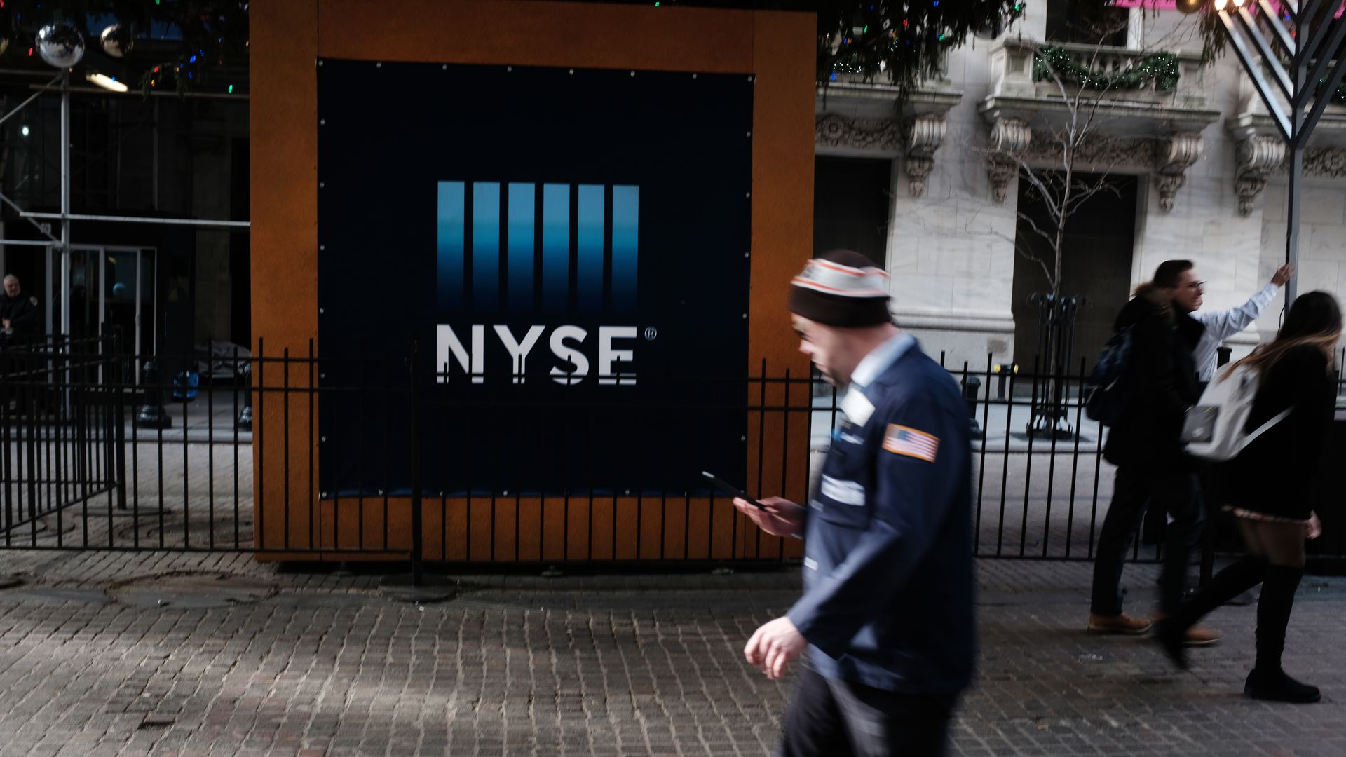 A trader walks in front of the New York Stock Exchange