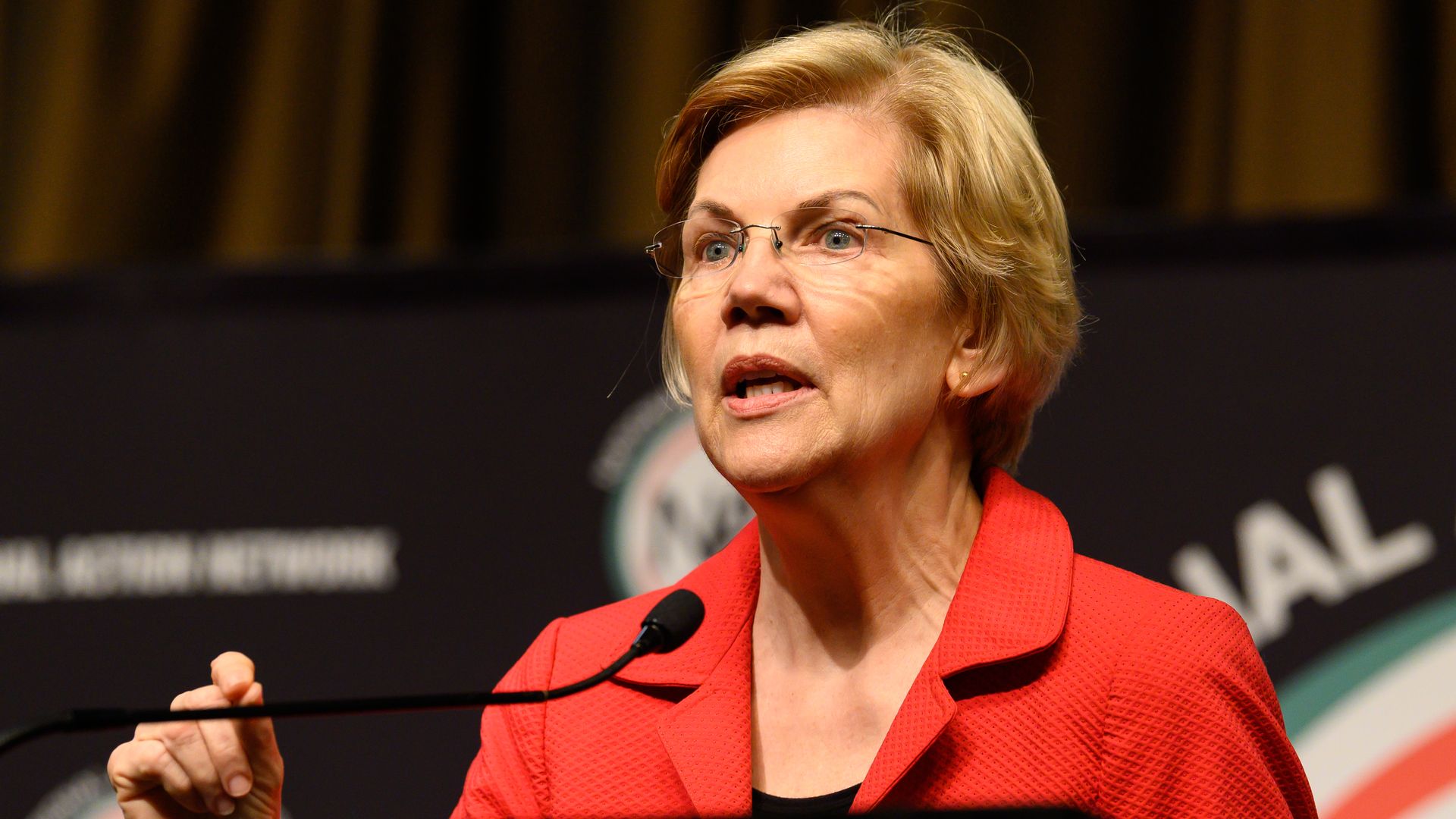 Elizabeth warren at a podium